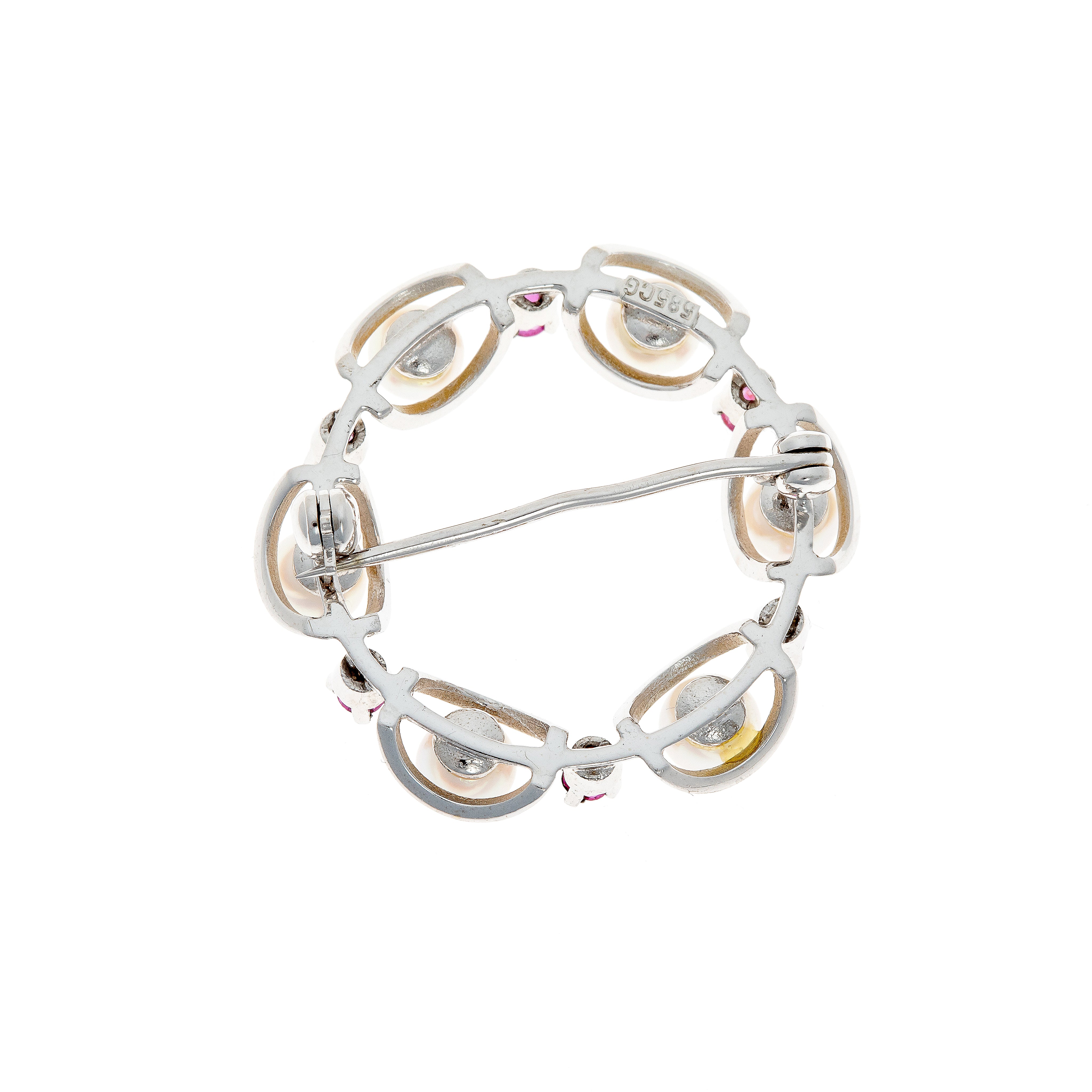 Back view of a Mid-Century white gold brooch, showing the intricate openwork setting and secure pin mechanism.