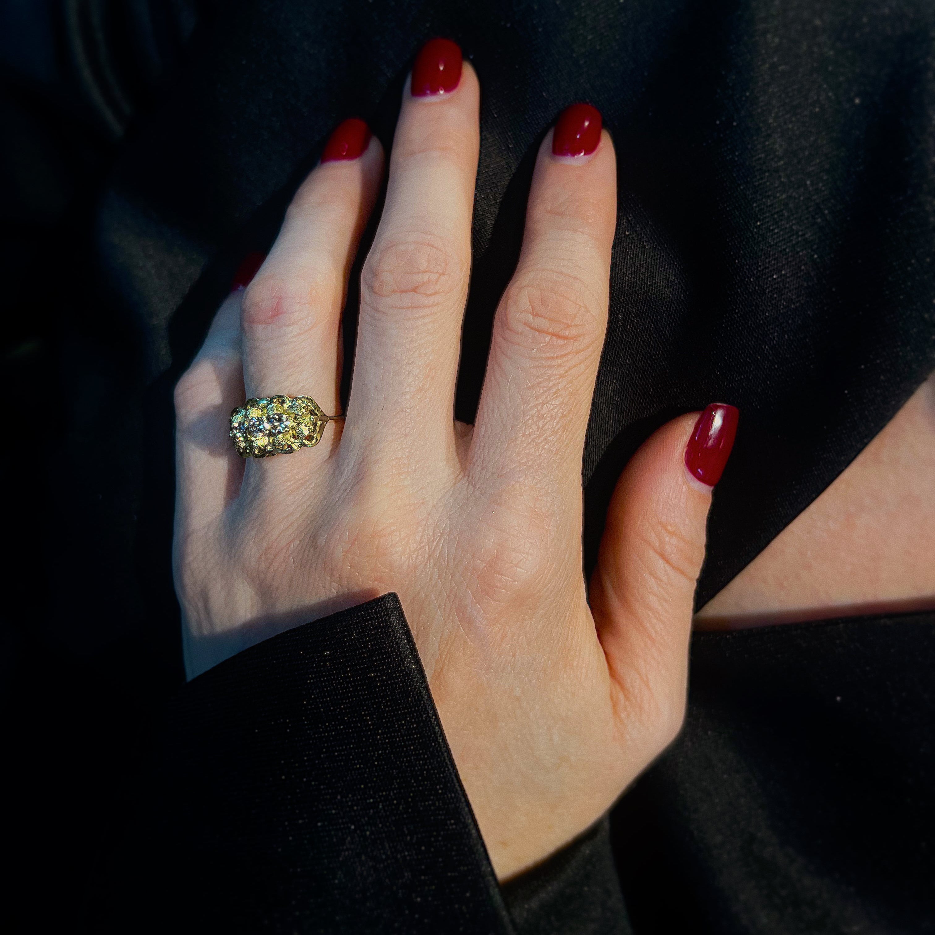 Woman wearing the Mid-Century modernist gold sculptural diamond trilogy ring.