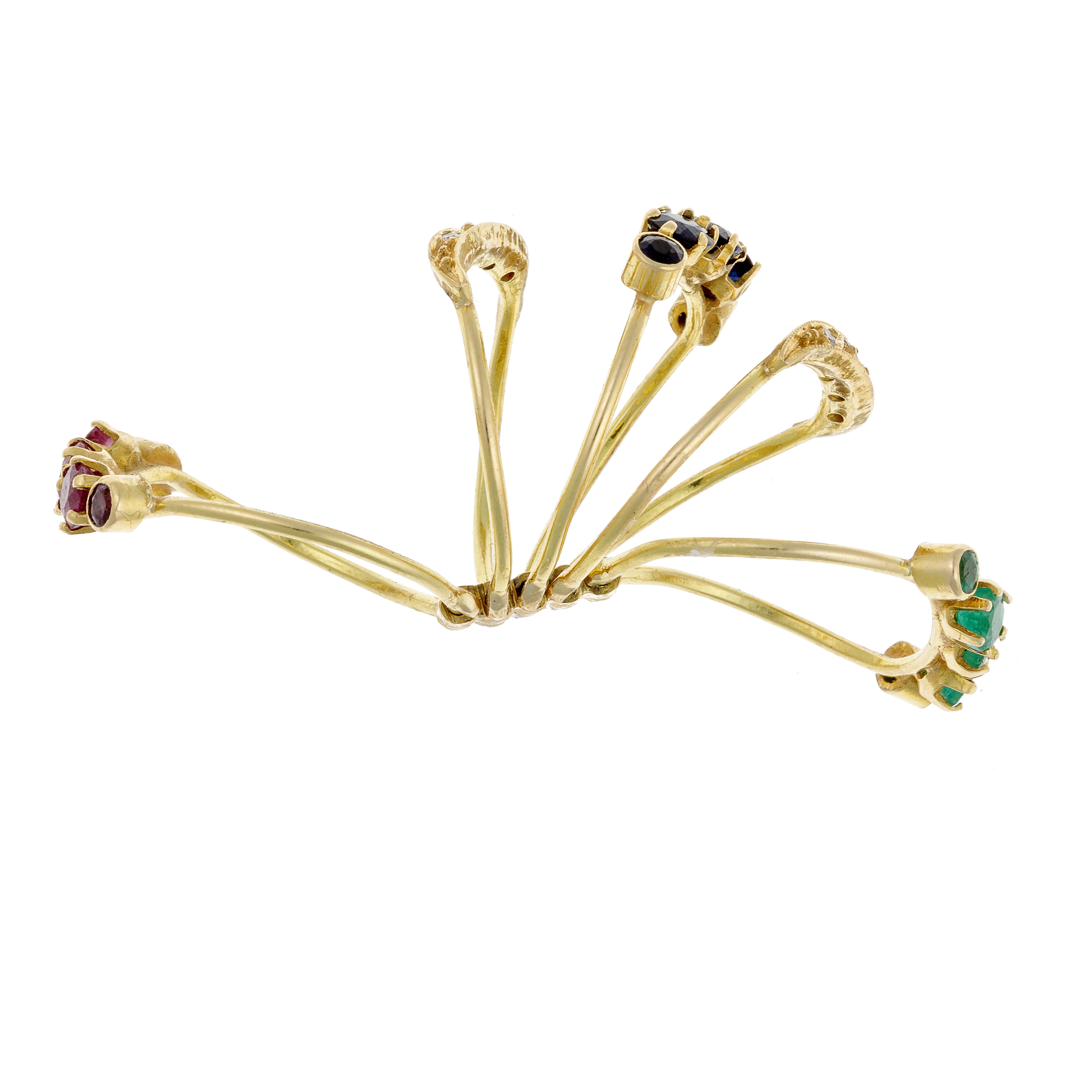 Top view of 18K gold ring showing staggered prong-set rubies, sapphires, emeralds, and diamonds.