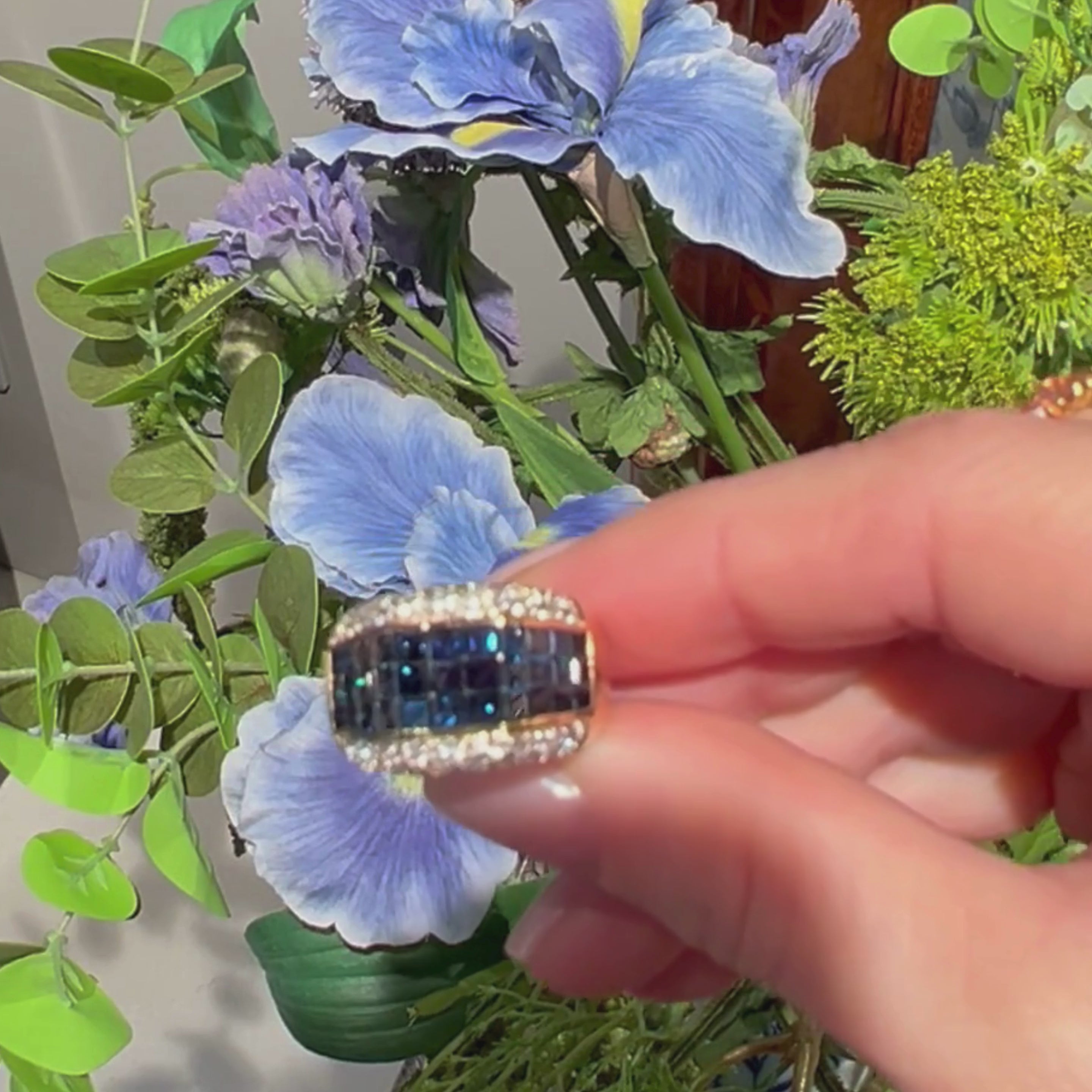 Video of woman showcasing the contemporary vintage blue and clear sapphire gold statement ring.