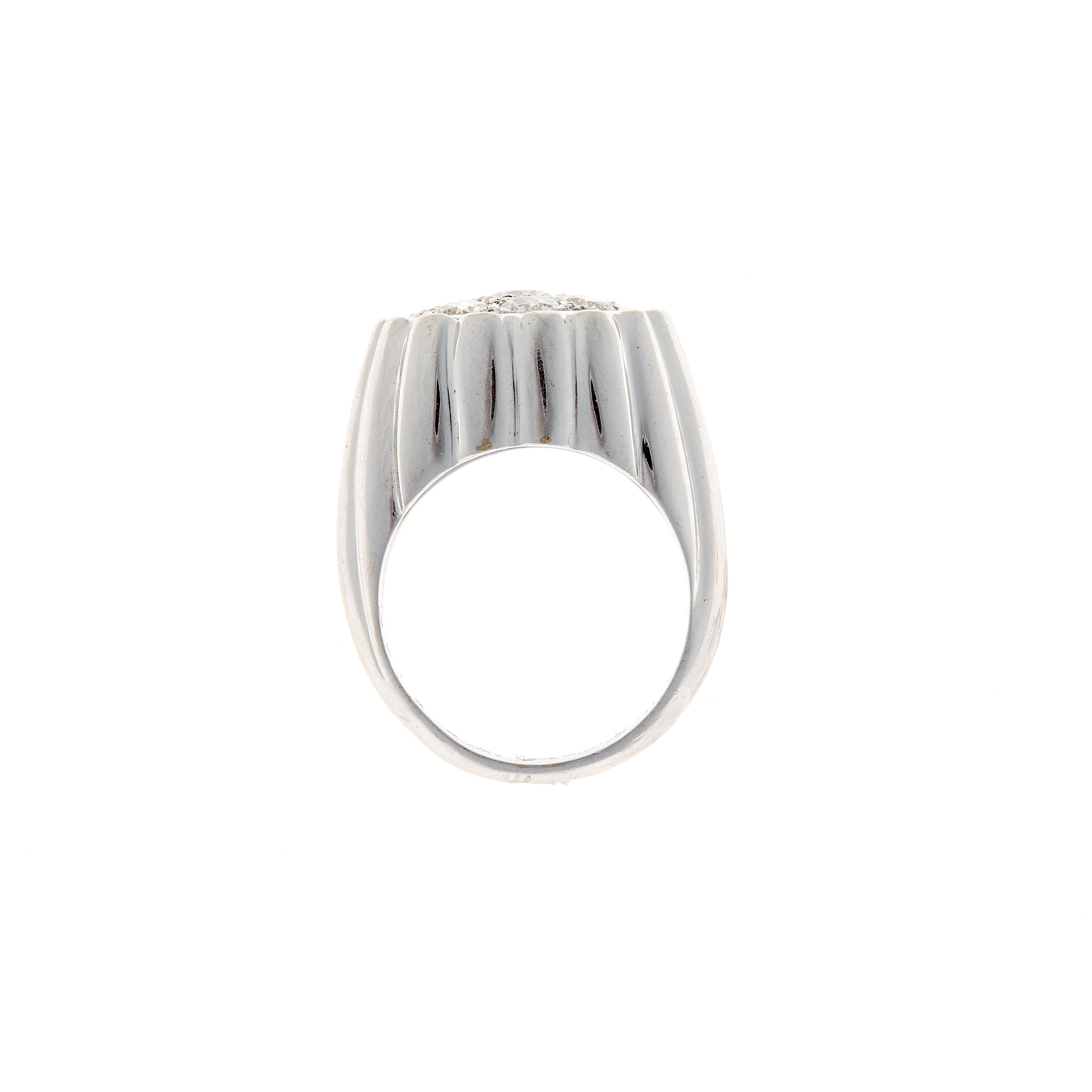 Profile view of a Retro white gold diamond ring, emphasizing its weighty gold construction and elevated setting.