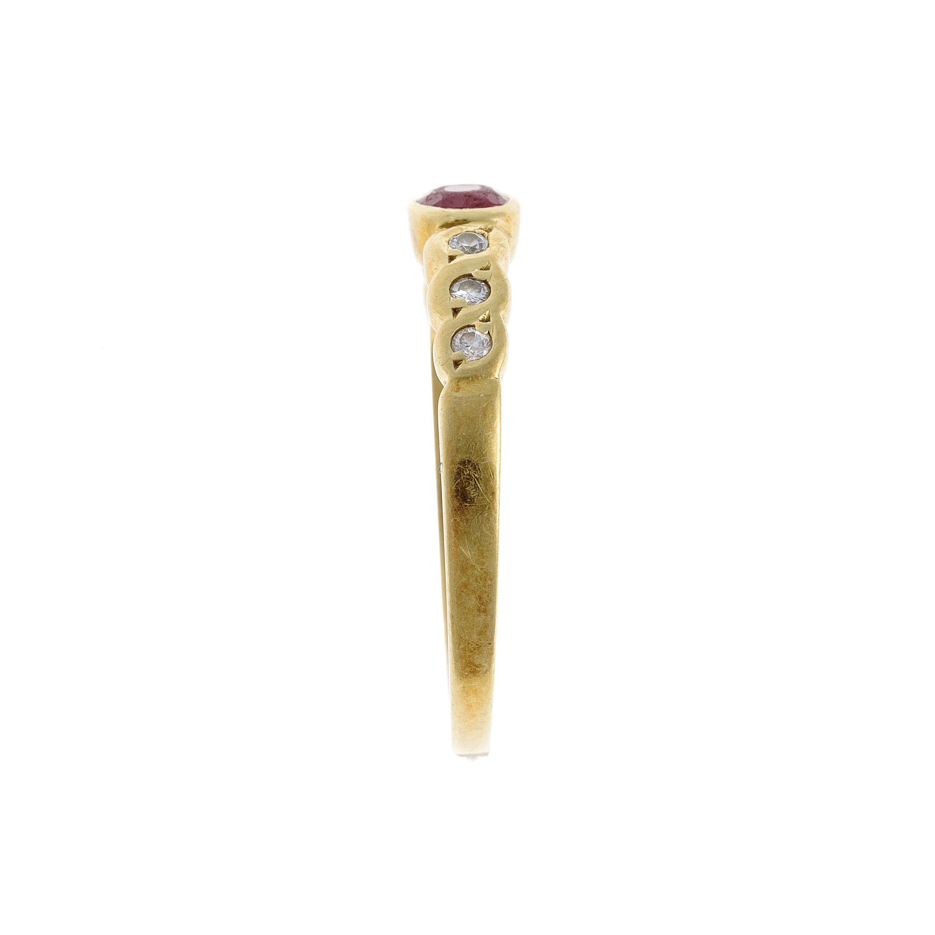 Side view of the retro ruby and diamond ring, highlighting the gold band’s sleek profile and symmetrical gemstone arrangement.