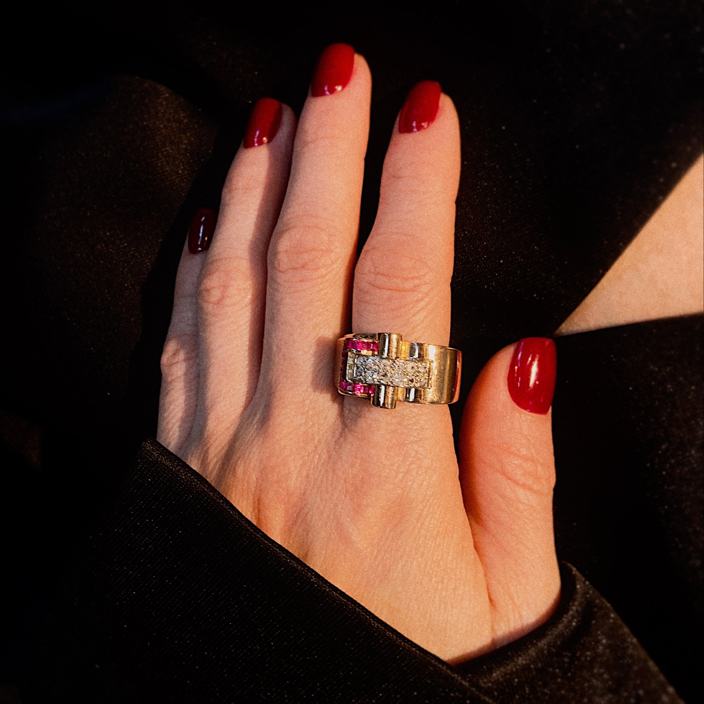 Model wearing the retro tank gold cocktail ring with diamonds and rubies.