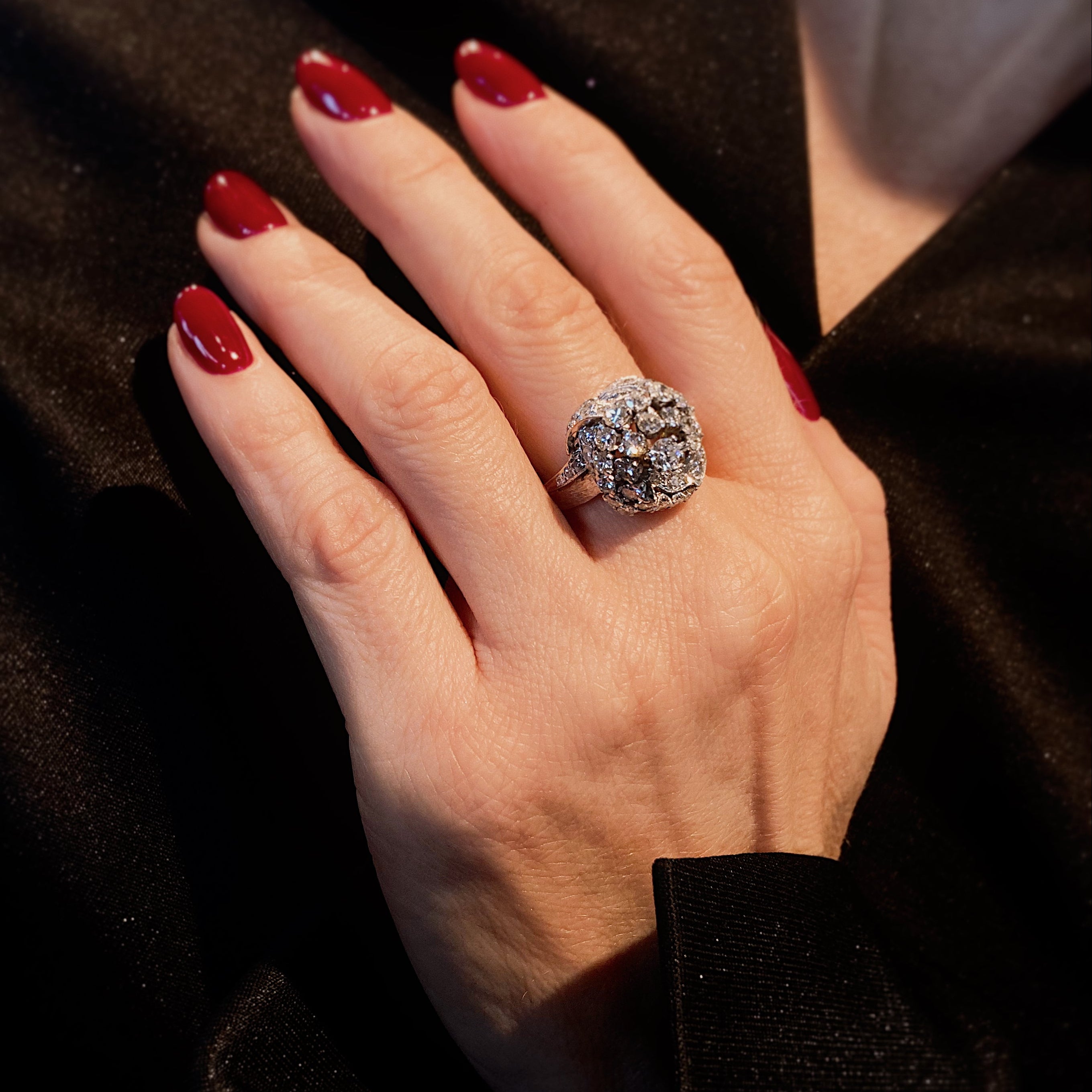 Woman wearing the Retro white gold sculptural diamond knot cocktail ring.