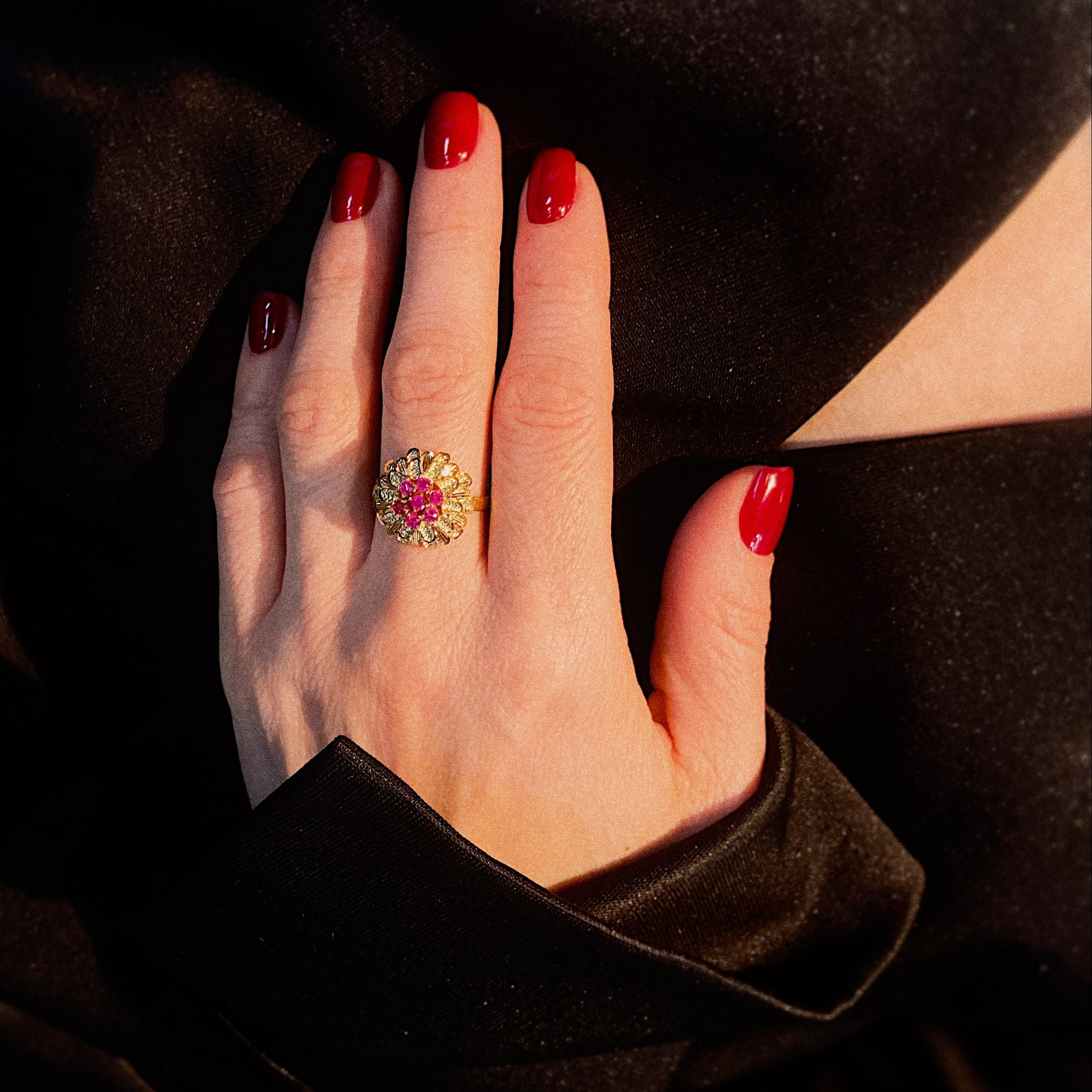 Model wearing the vintage gold cocktail ring with rubies and synthetic corundum.