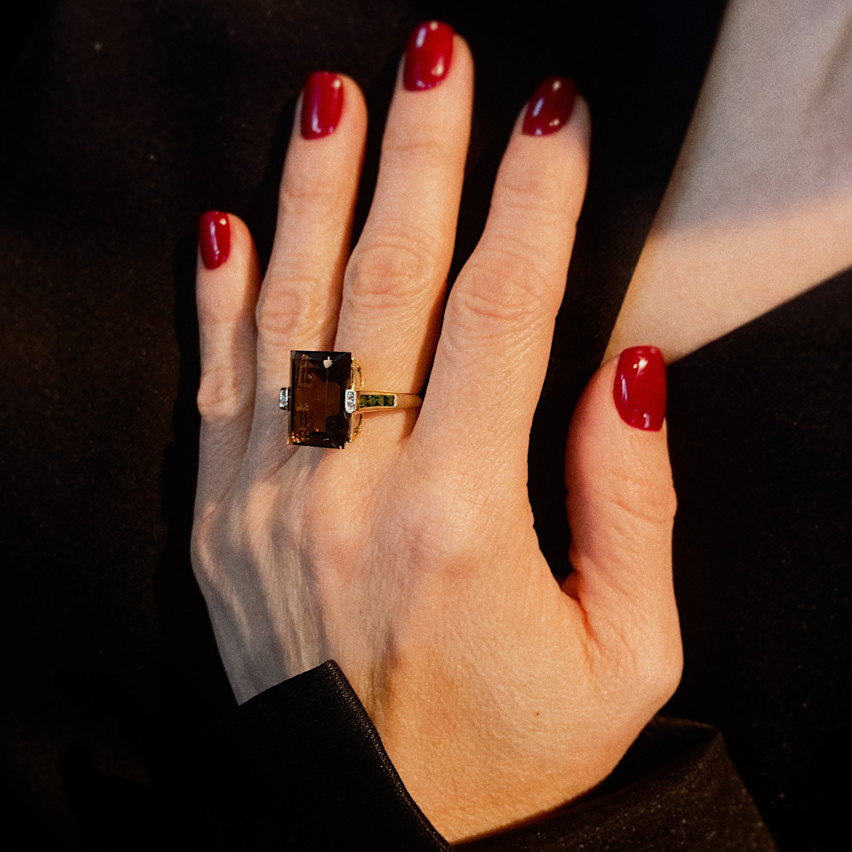 Model wearing the vintage gold smoky quartz and emerald cocktail statement ring.