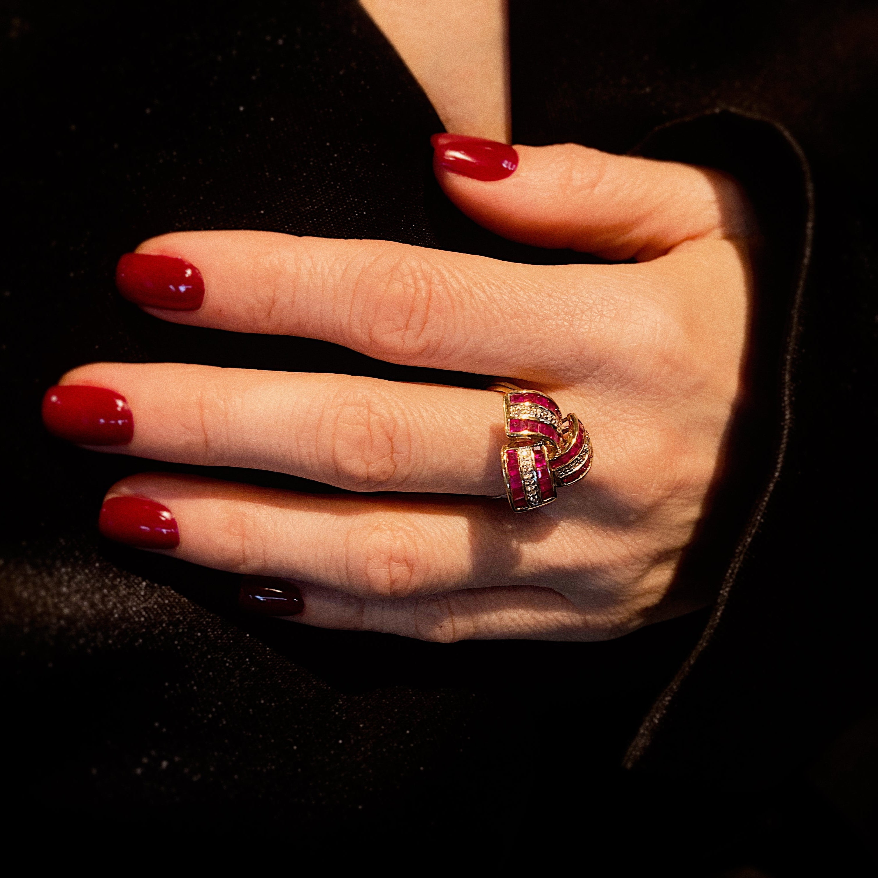 Model hand wearing the 1940s tank style cocktail ring with rubies and diamonds.