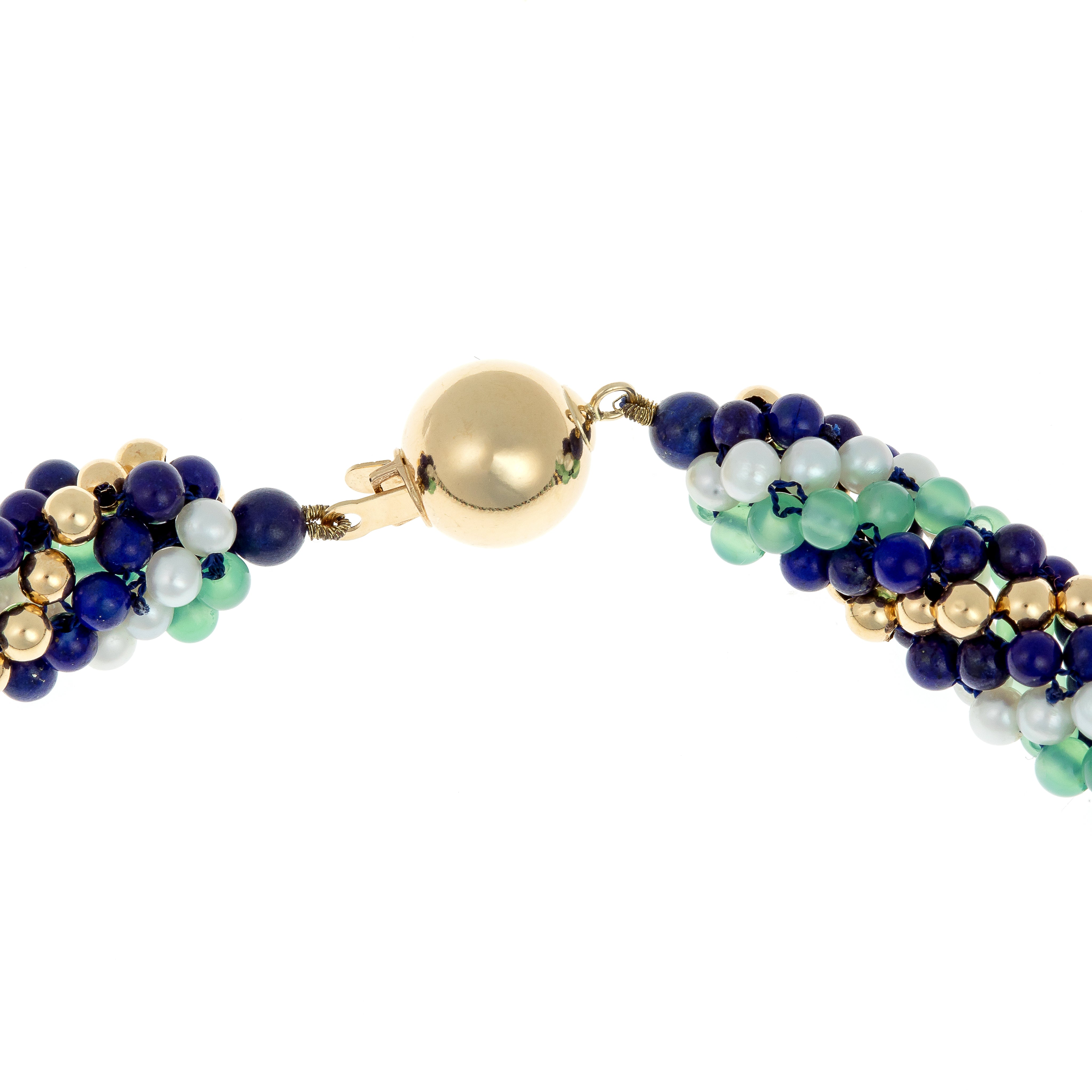 Close-up of the 18K gold spherical clasp on a torsade necklace with tourmaline, lapis lazuli, and cultured pearls.