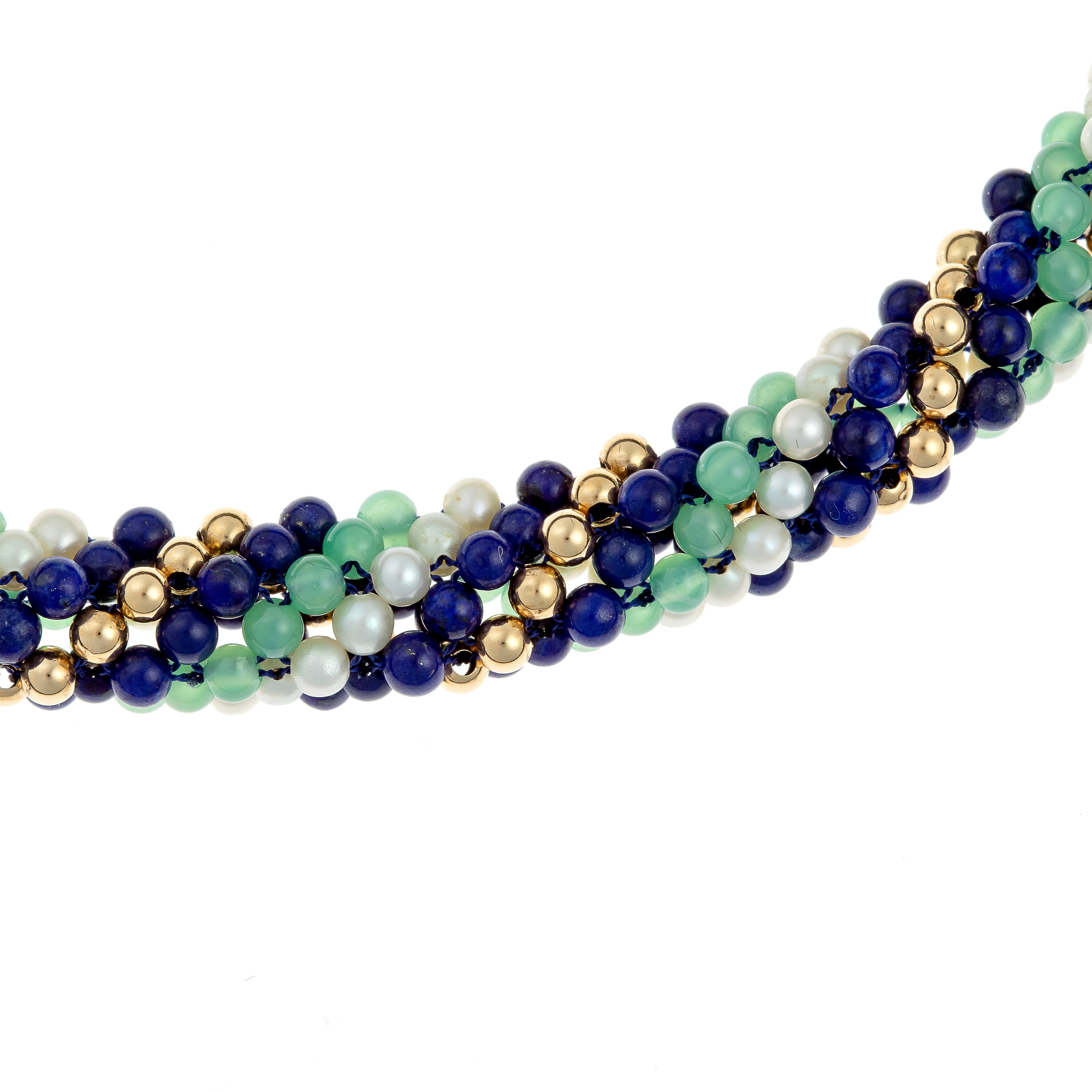 Detailed view of the gemstone beads in a torsade necklace featuring tourmaline, lapis lazuli, cultured pearls, and 18K gold accents.