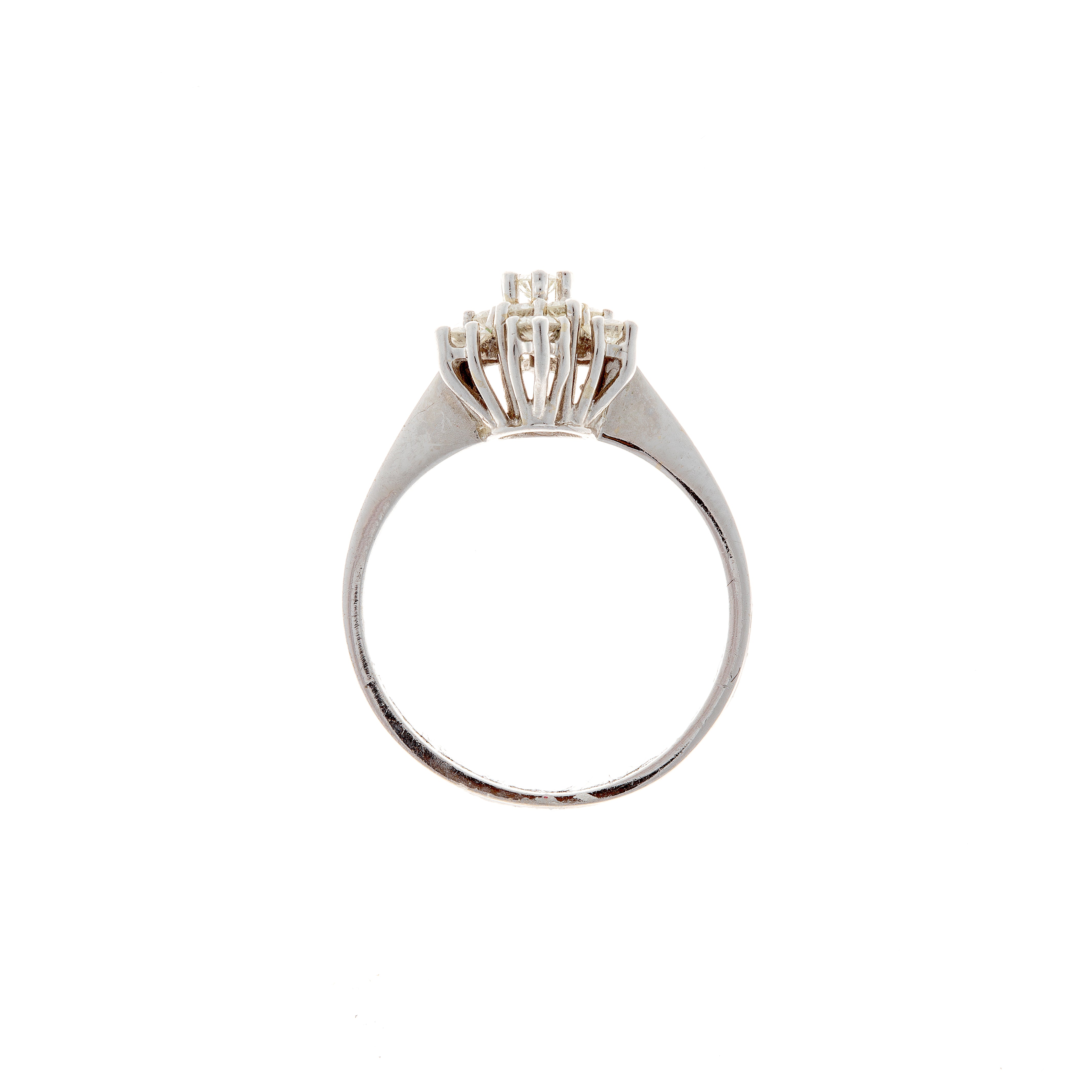 Profile view displaying the openwork gallery on a vintage white gold diamond cluster ring, designed to enhance light reflection.