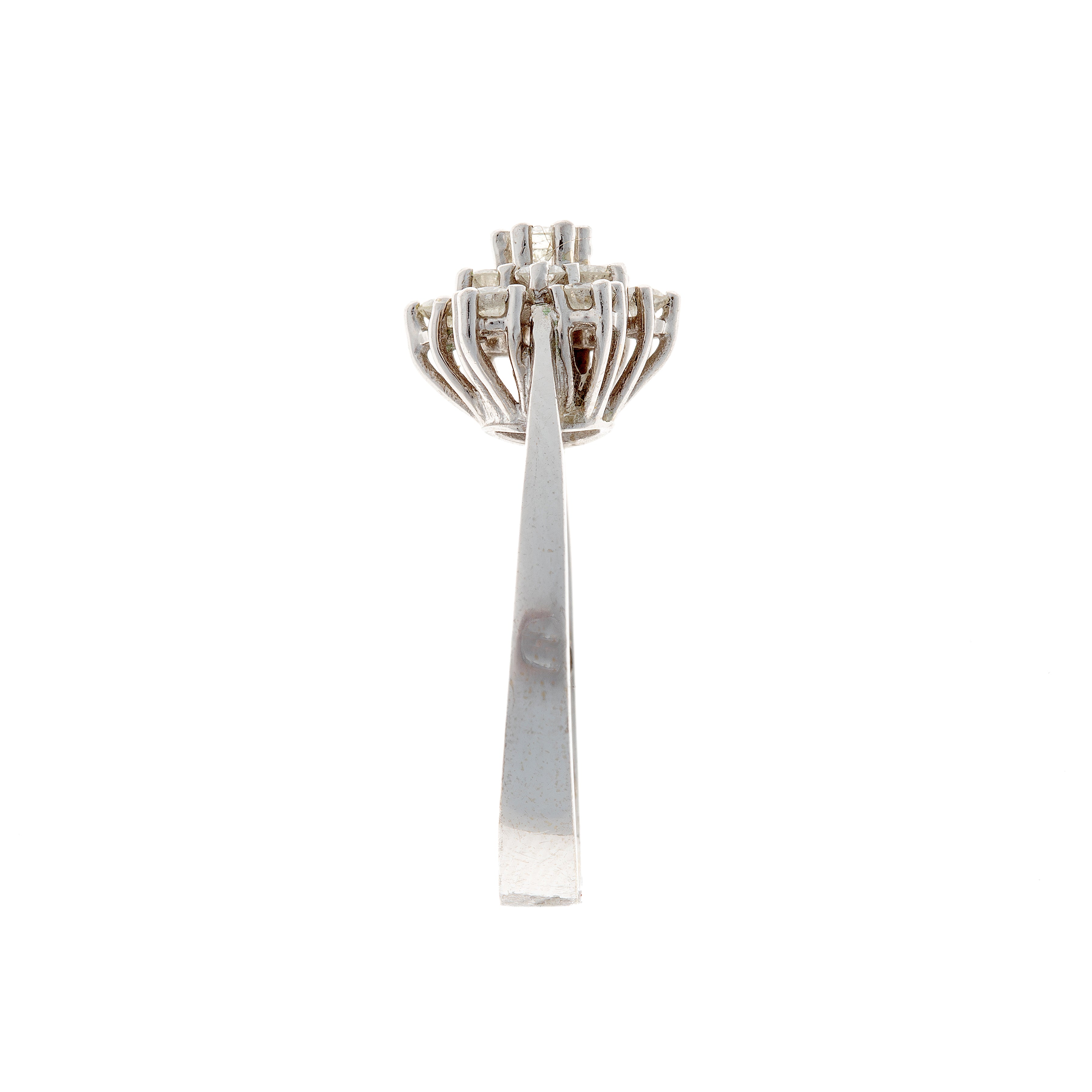 Side profile of a vintage diamond cluster ring, highlighting its tapered white gold band and elevated gallery setting.