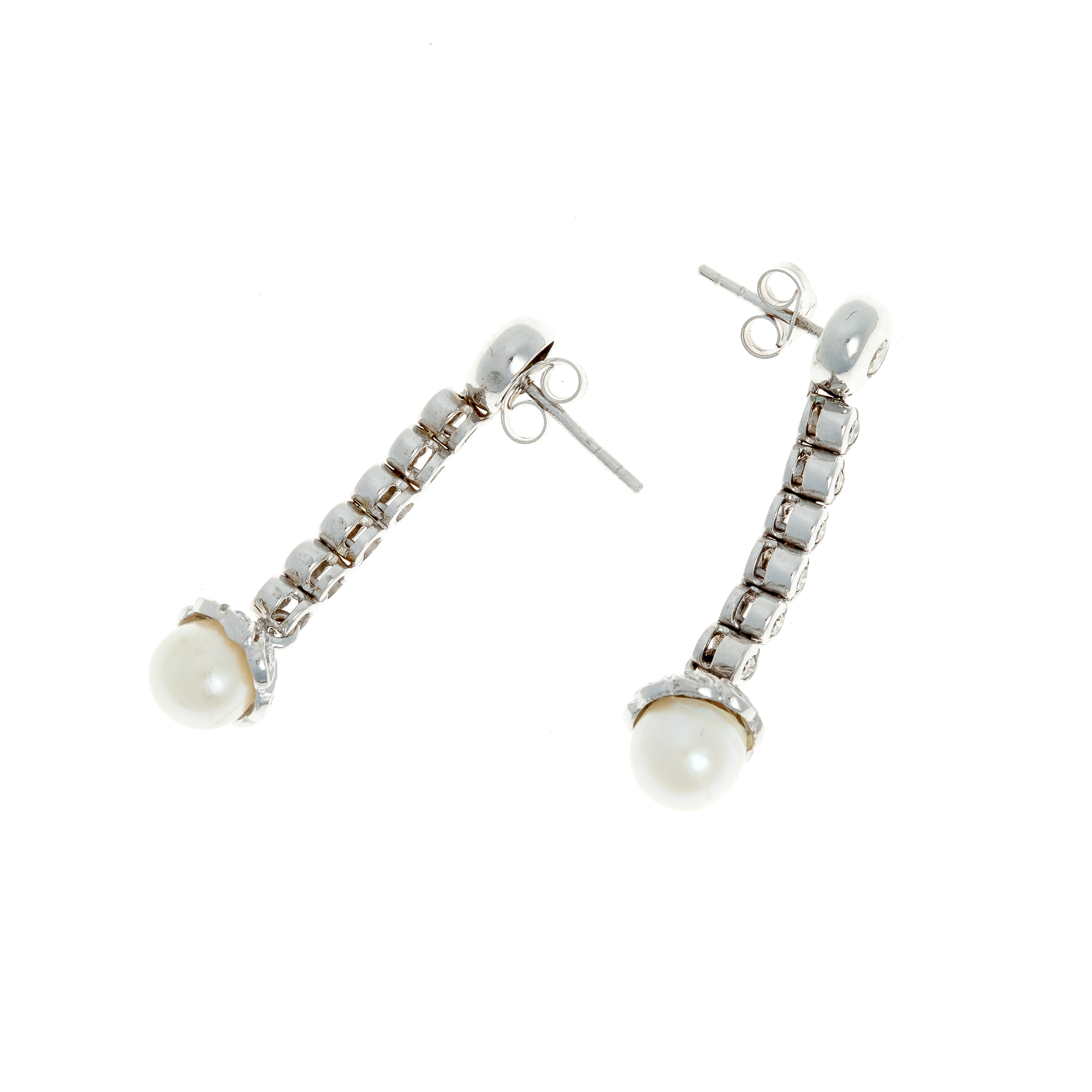 Pair of German white gold earrings with bezel-set diamonds and pearls from the 1970s.