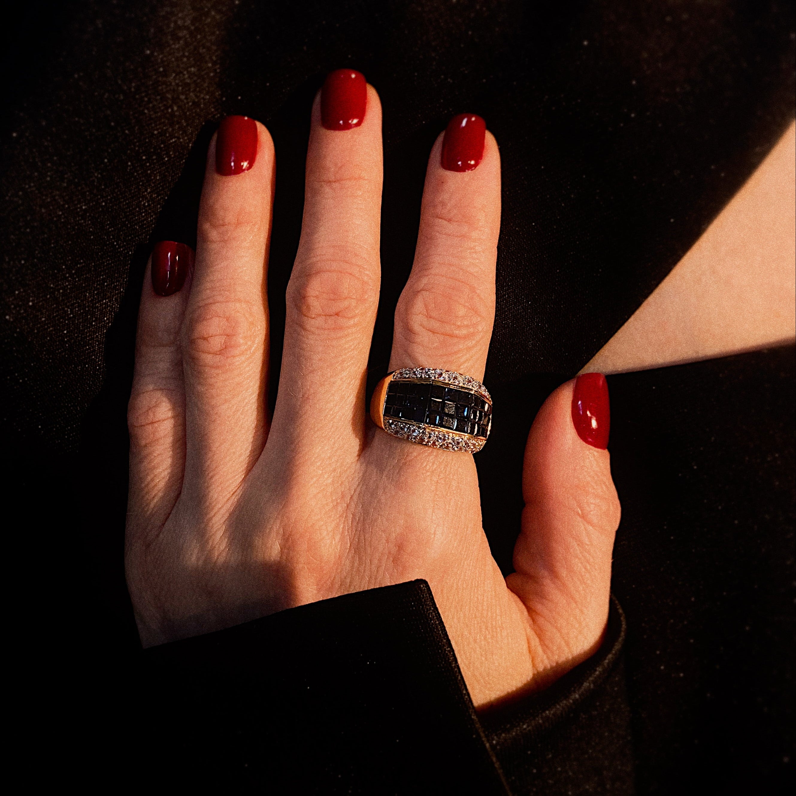 Model wearing the contemporary vintage blue and clear sapphire gold statement ring.