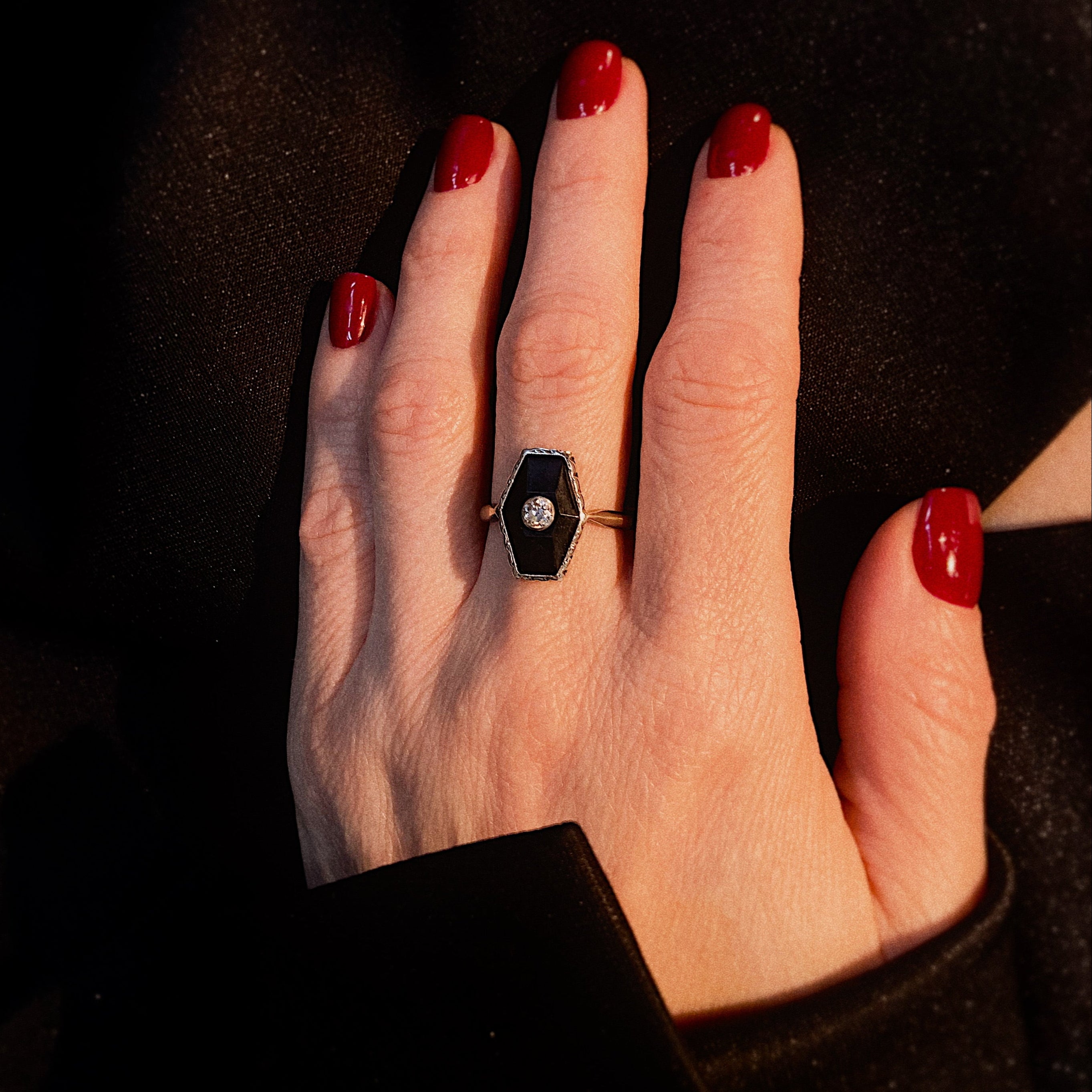 Model wearing the art deco 9k gold and silver cocktail ring with diamond and onyx.