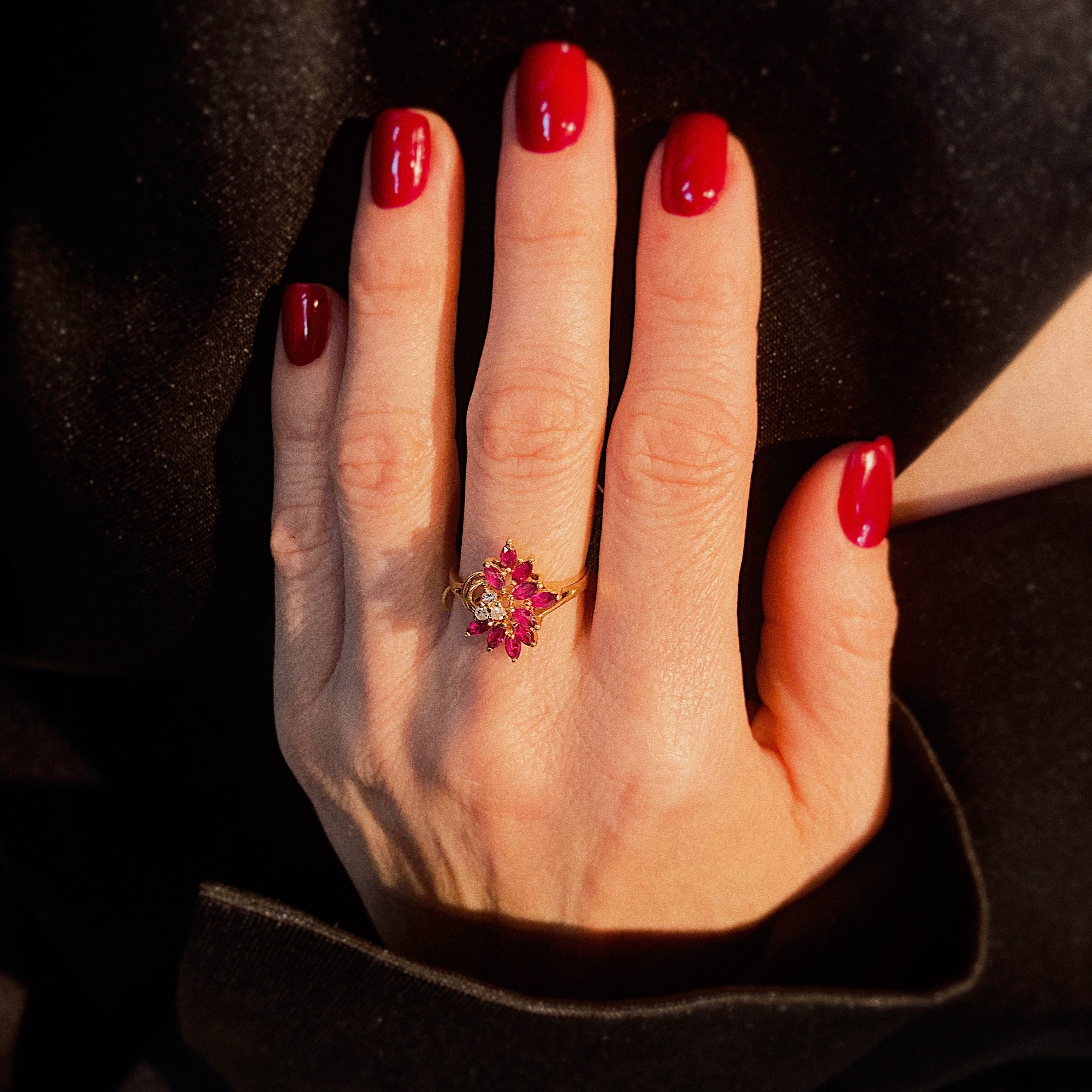 Model wearing the asymmetrical vintage gold ring with diamonds and rubies.