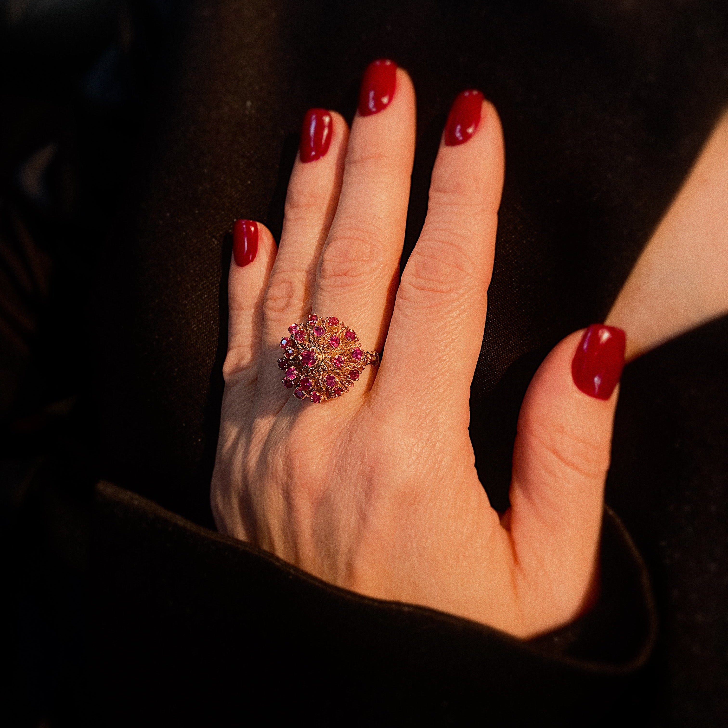Model wearing bespoke vintage ruby cluster gold cocktail ring.