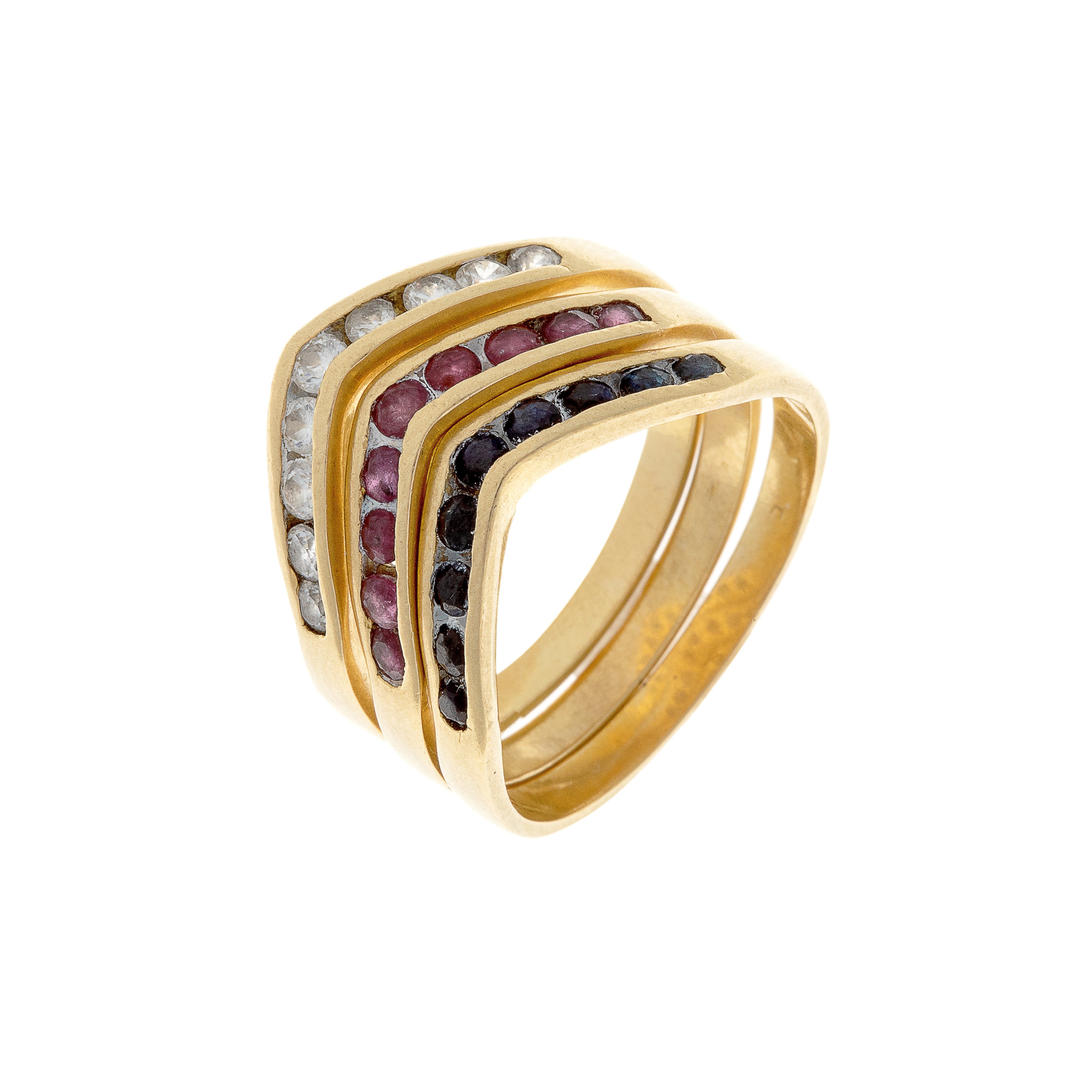 Angled view of French-crafted gold rings stacked in a chevron shape with channel-set rubies and sapphires.