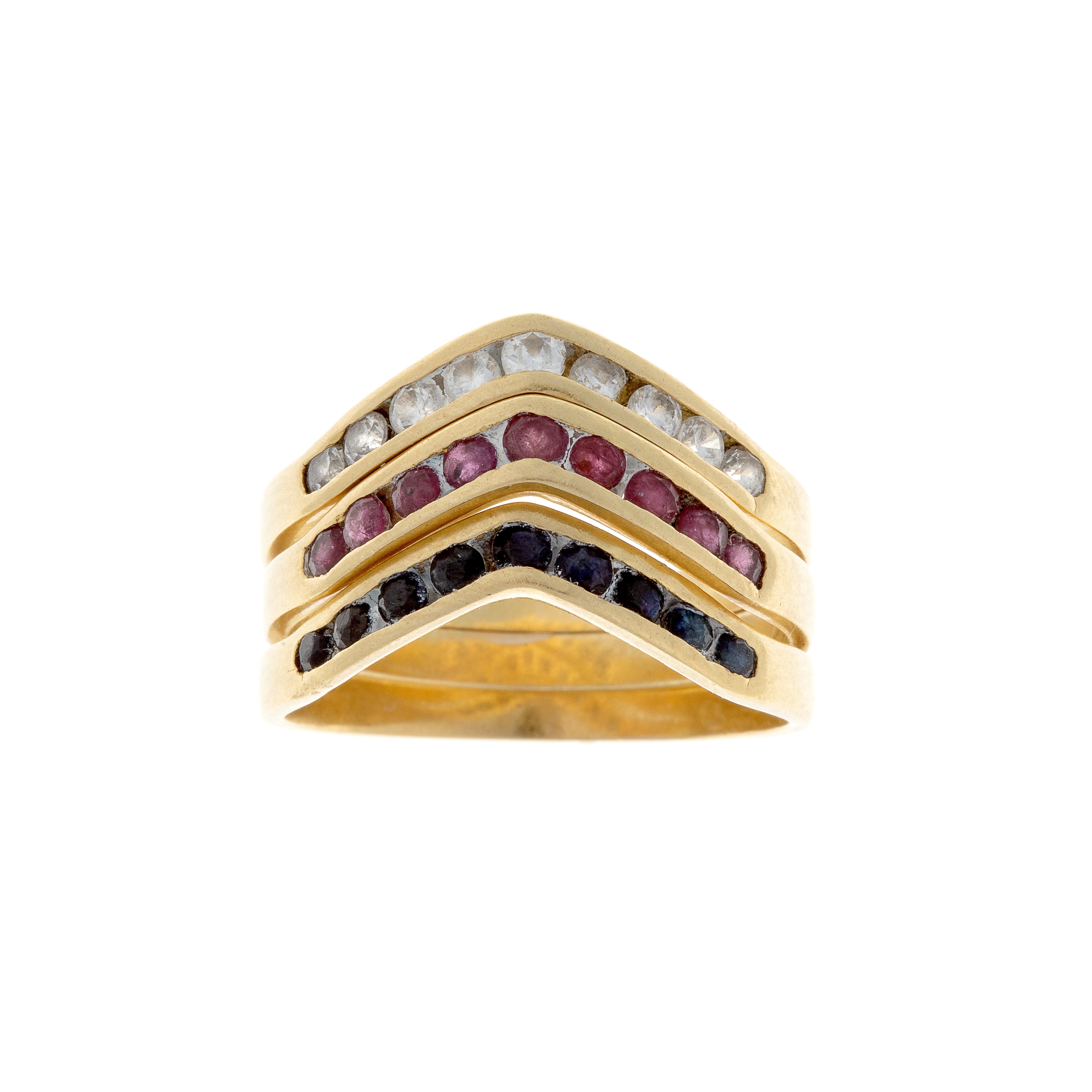 Three vintage stacking chevron gold rings with rubies and sapphires in gradient hues.