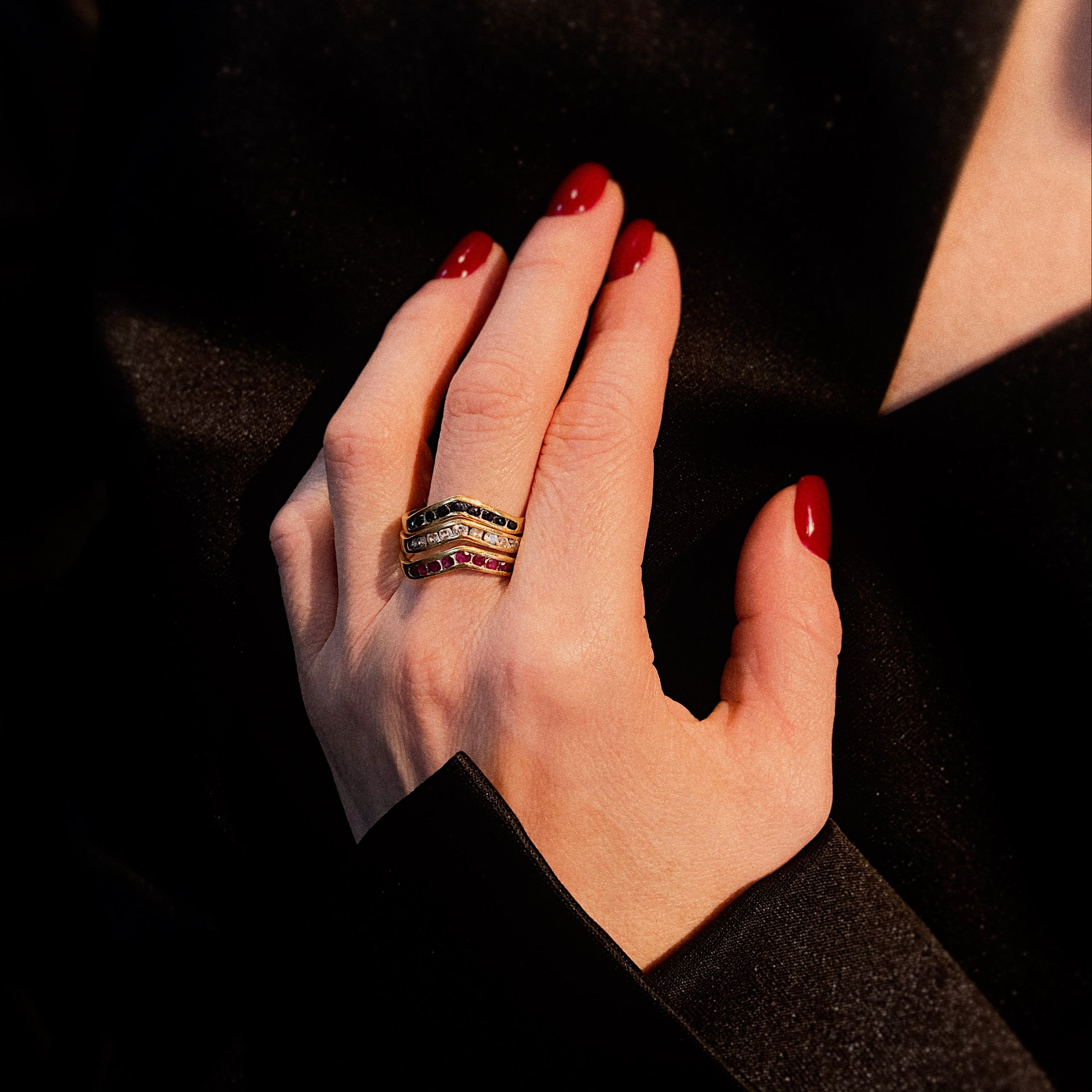 Model wearing the three vintage gold chevron rings with sapphires, and rubies.