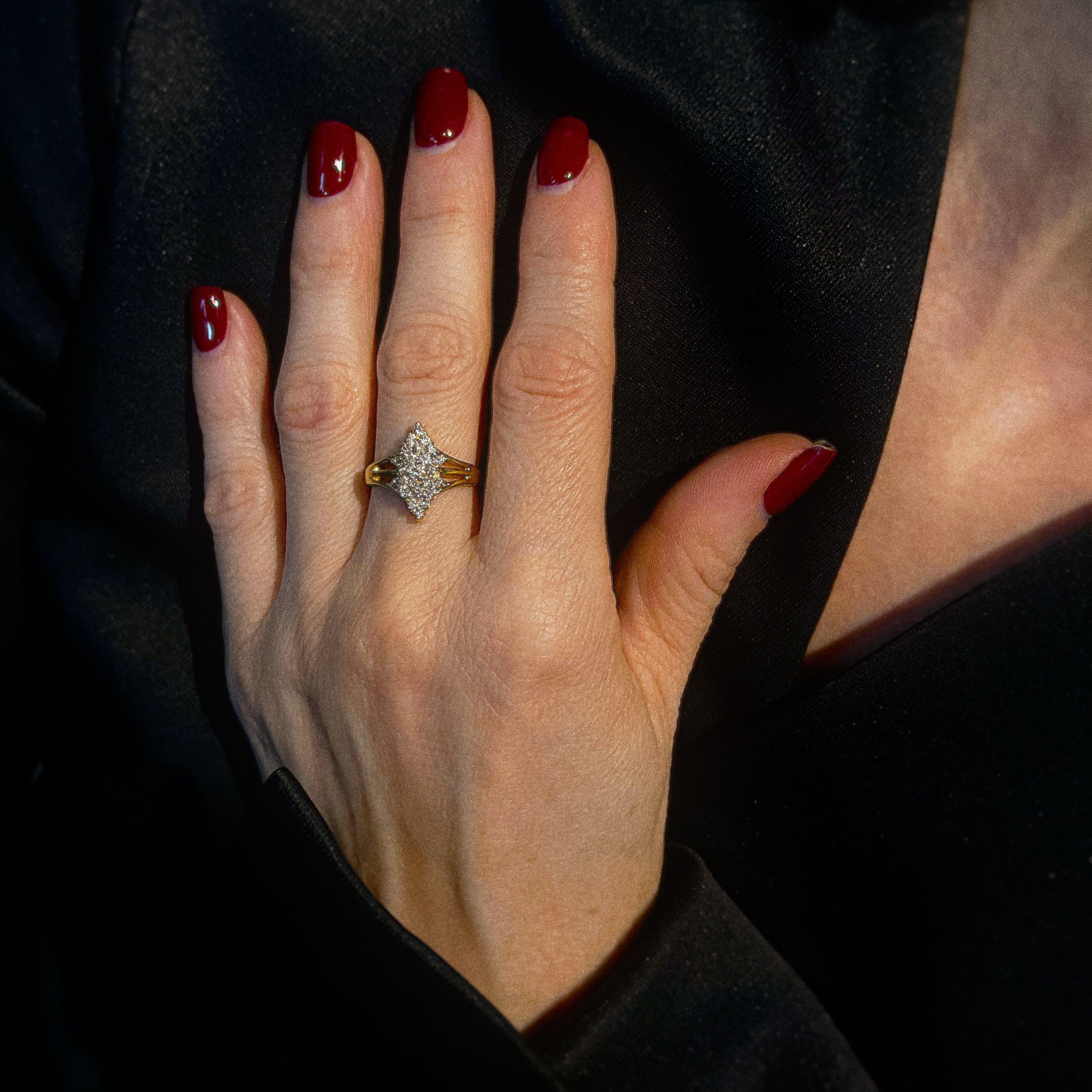 Model wearing the vintage gold symmetrical diamond cluster cocktail ring.