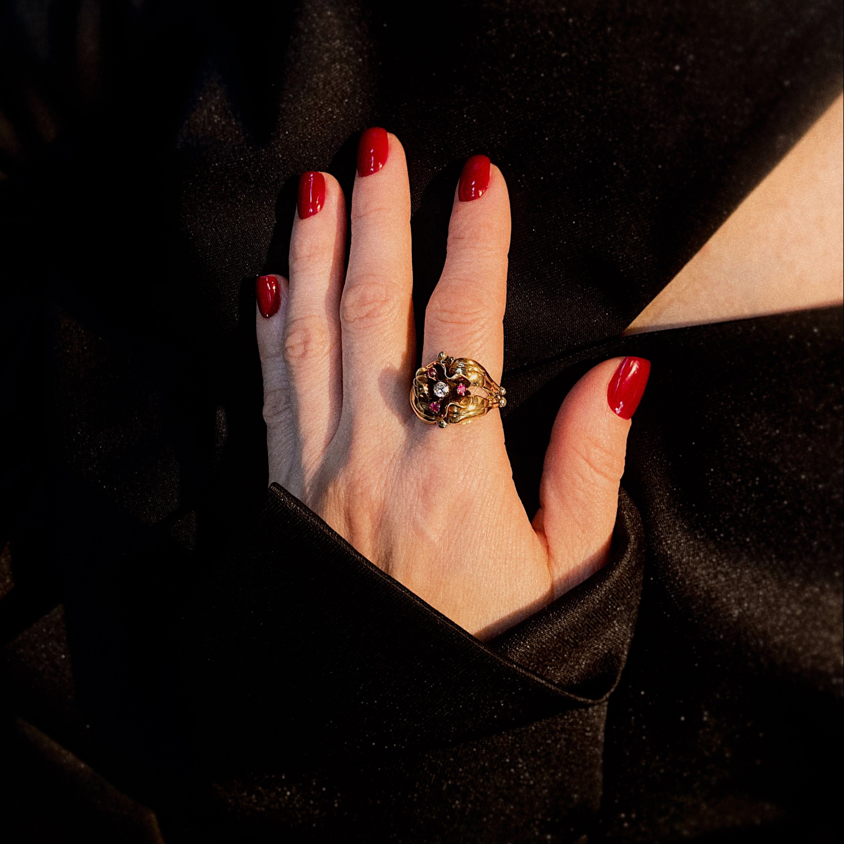 Model wearing the vintage floral gold ring with a diamond and lab-grown rubies.