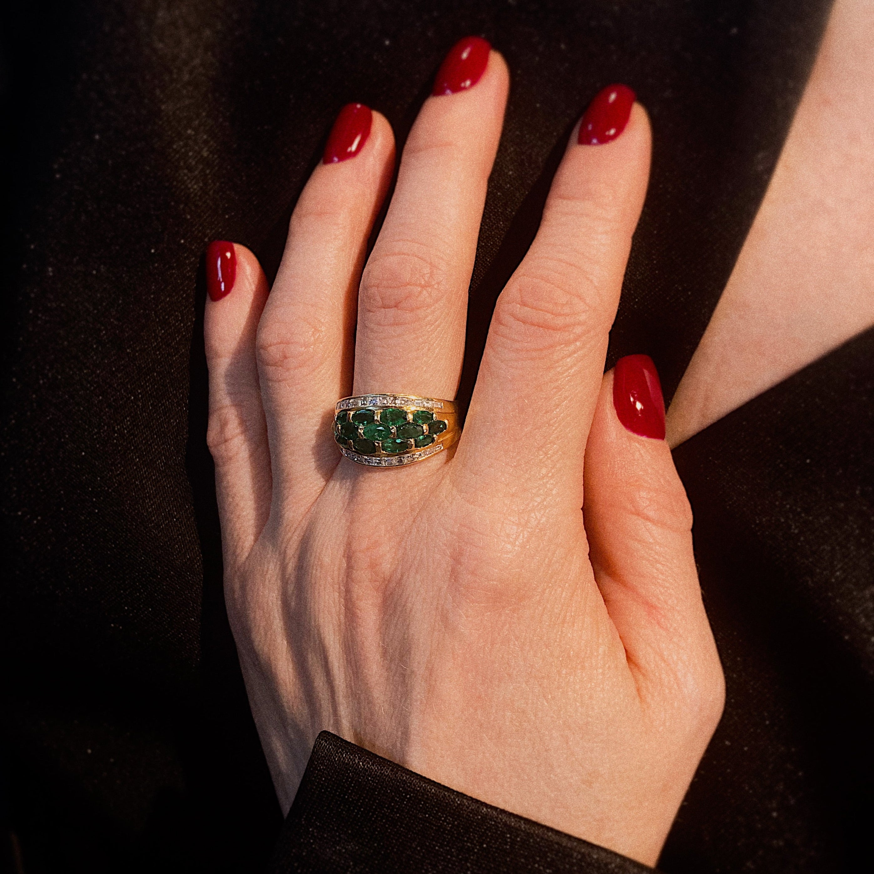 Model wearing the vintage gold emerald and diamond cocktail ring.