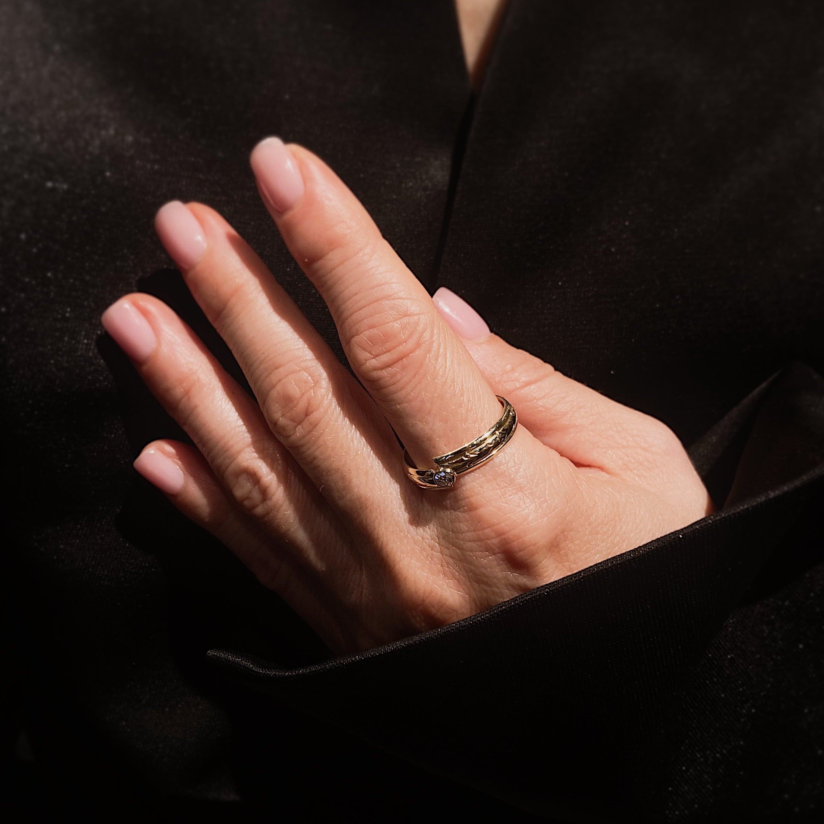 Woman wearing the contemporary vintage engraved yellow gold diamond bypass ring.