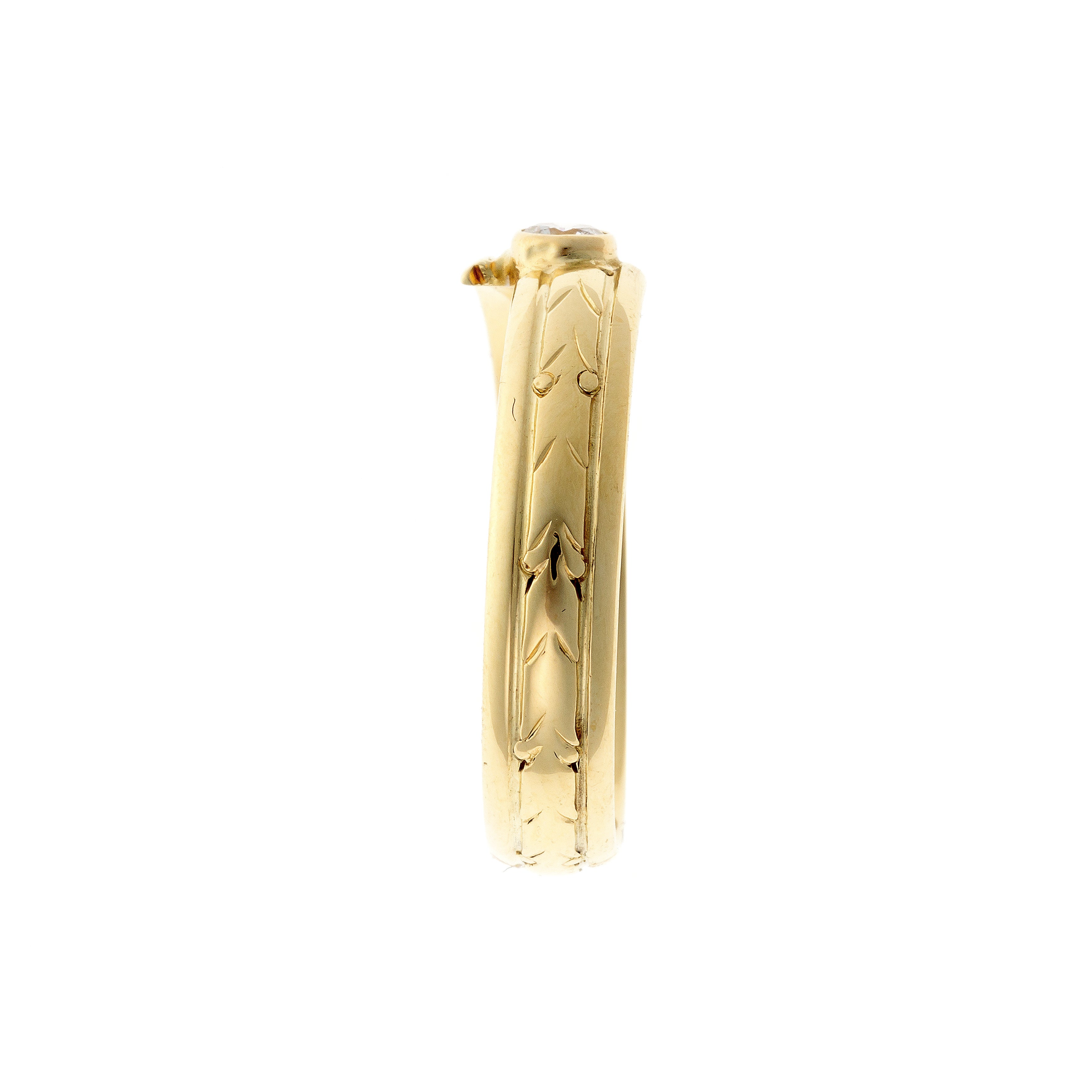 Side of the contemporary vintage engraved yellow gold diamond bypass ring.