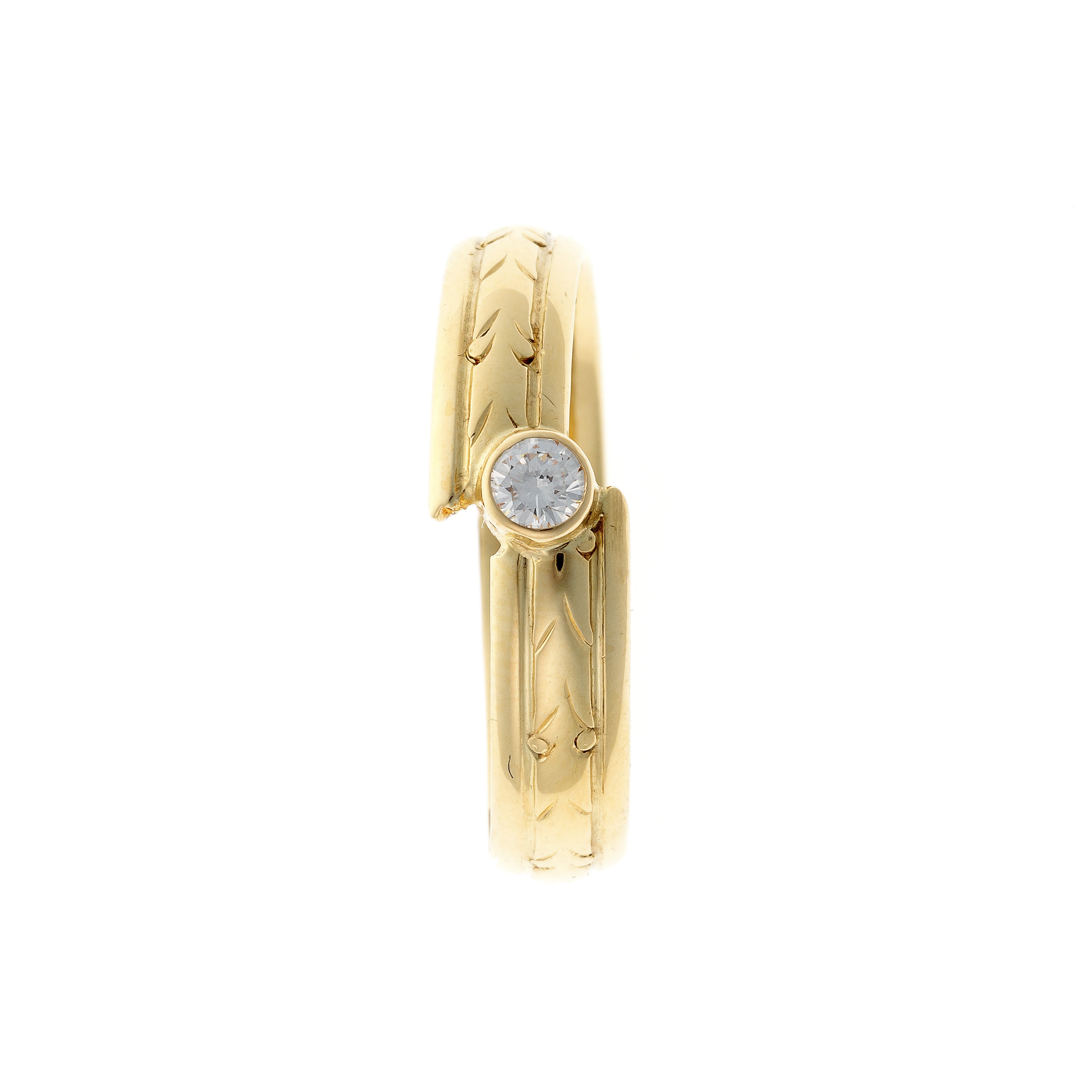 Top of the contemporary vintage engraved yellow gold diamond bypass ring.