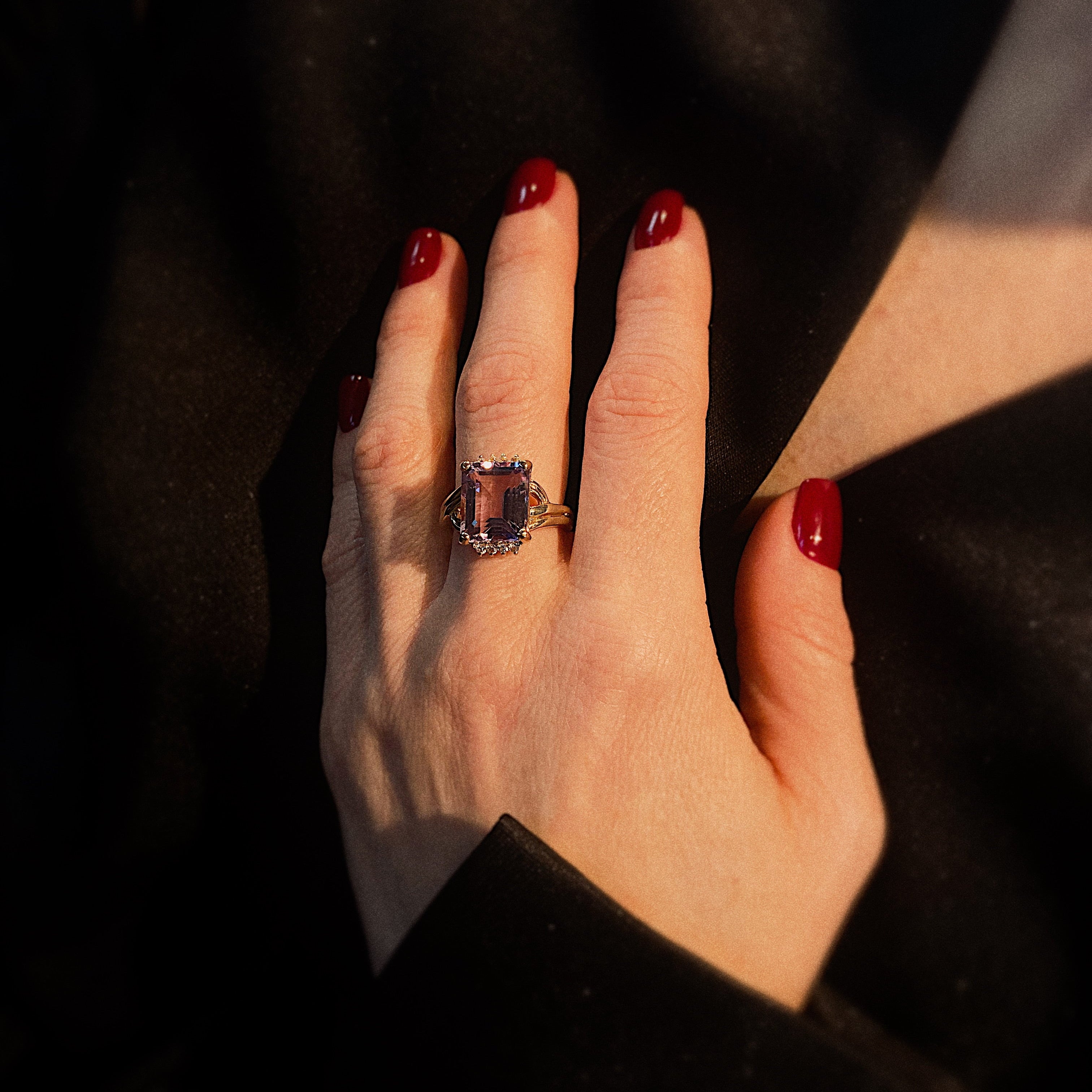 Model wearing the vintage gold cocktail ring with amethyst and topaz accents.