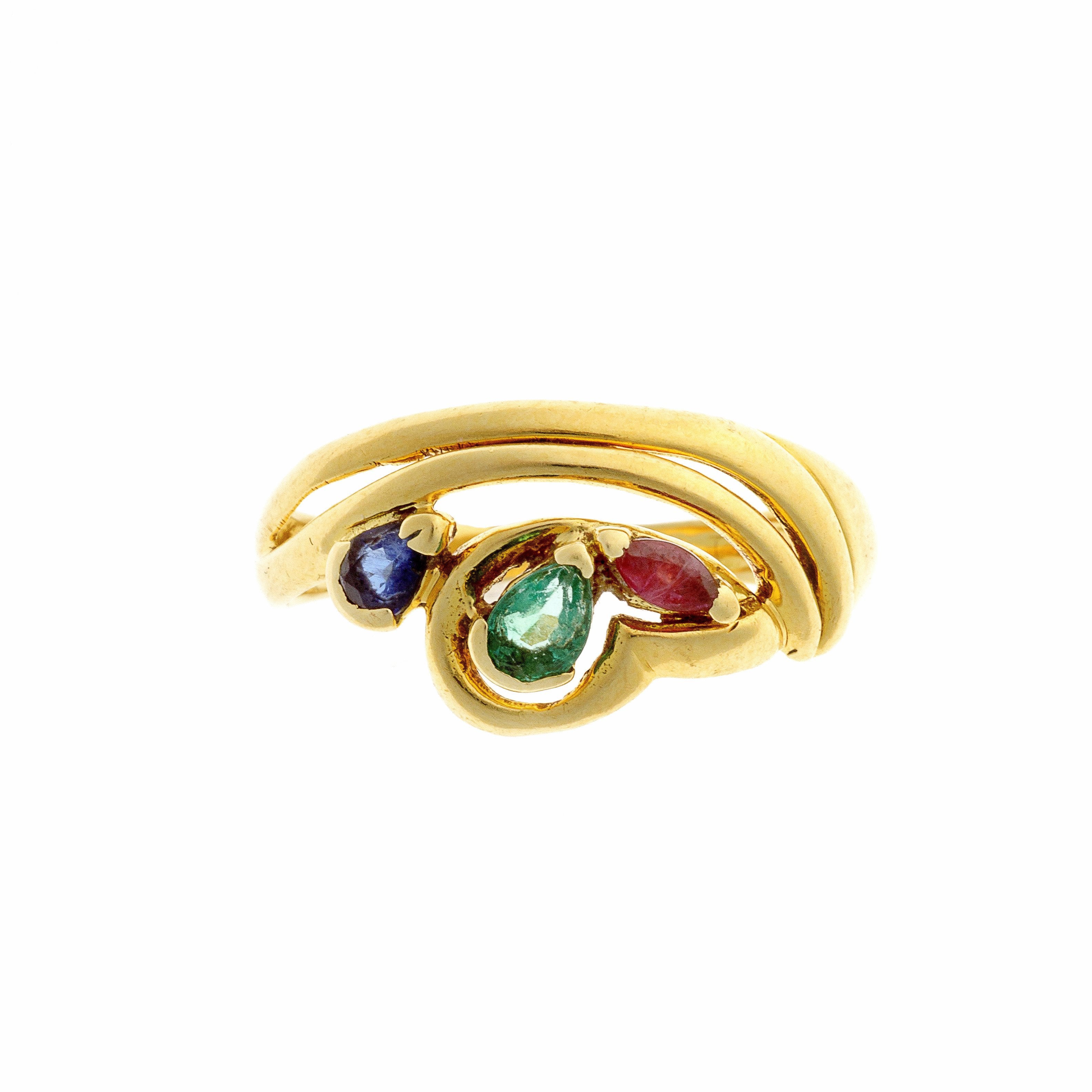 Vintage 18K gold cocktail ring featuring emerald, sapphire, and ruby in a fluid, sculptural setting.