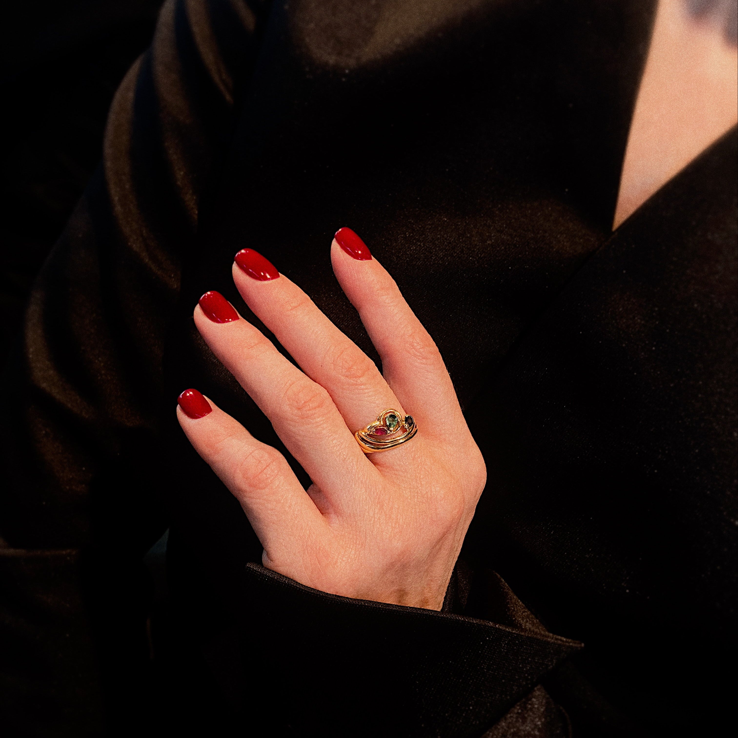 Model wearing the vintage gold bypass cocktail ring with ruby, emerald and sapphire.