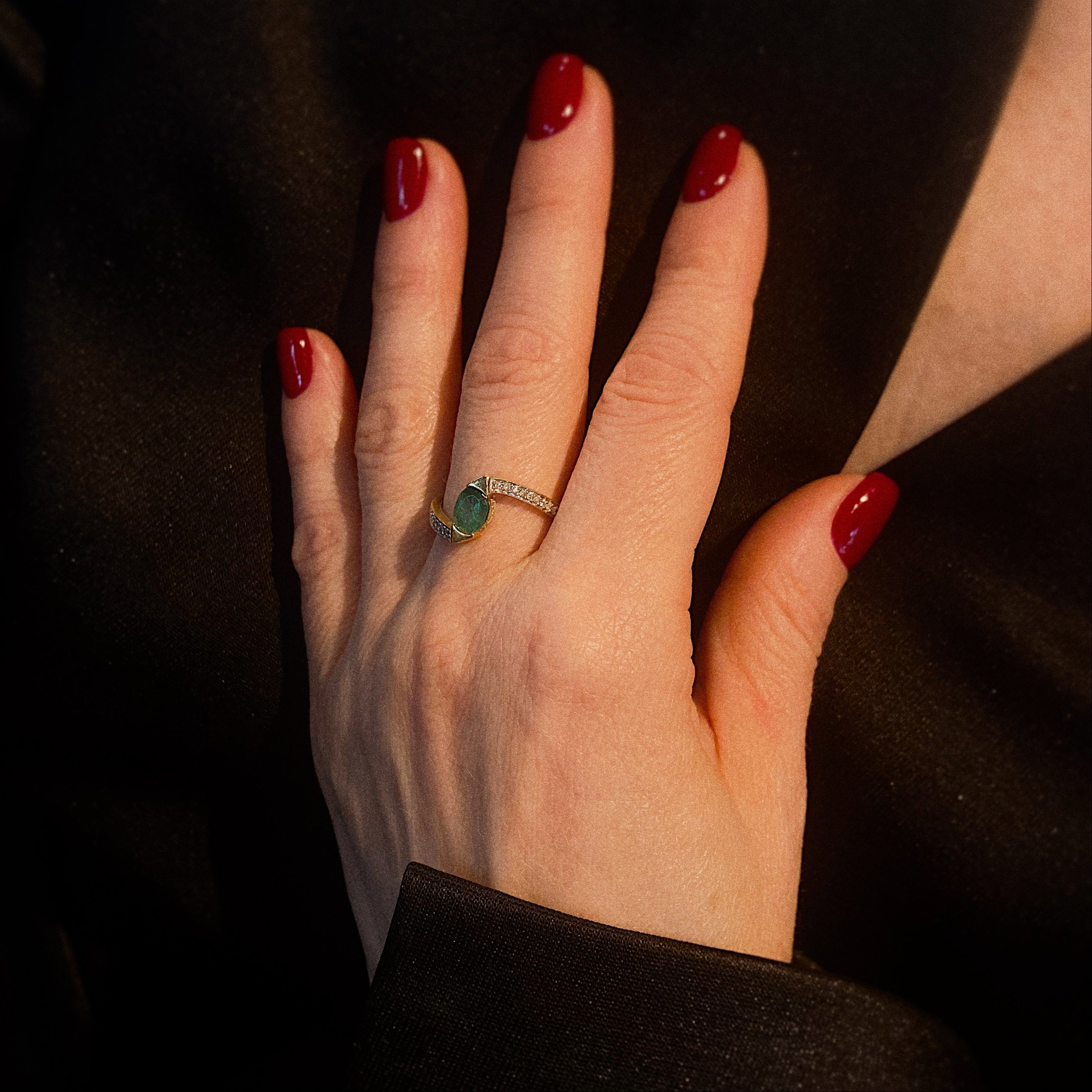 Model wearing the vintage gold  emerald and diamond cocktail bypass ring.
