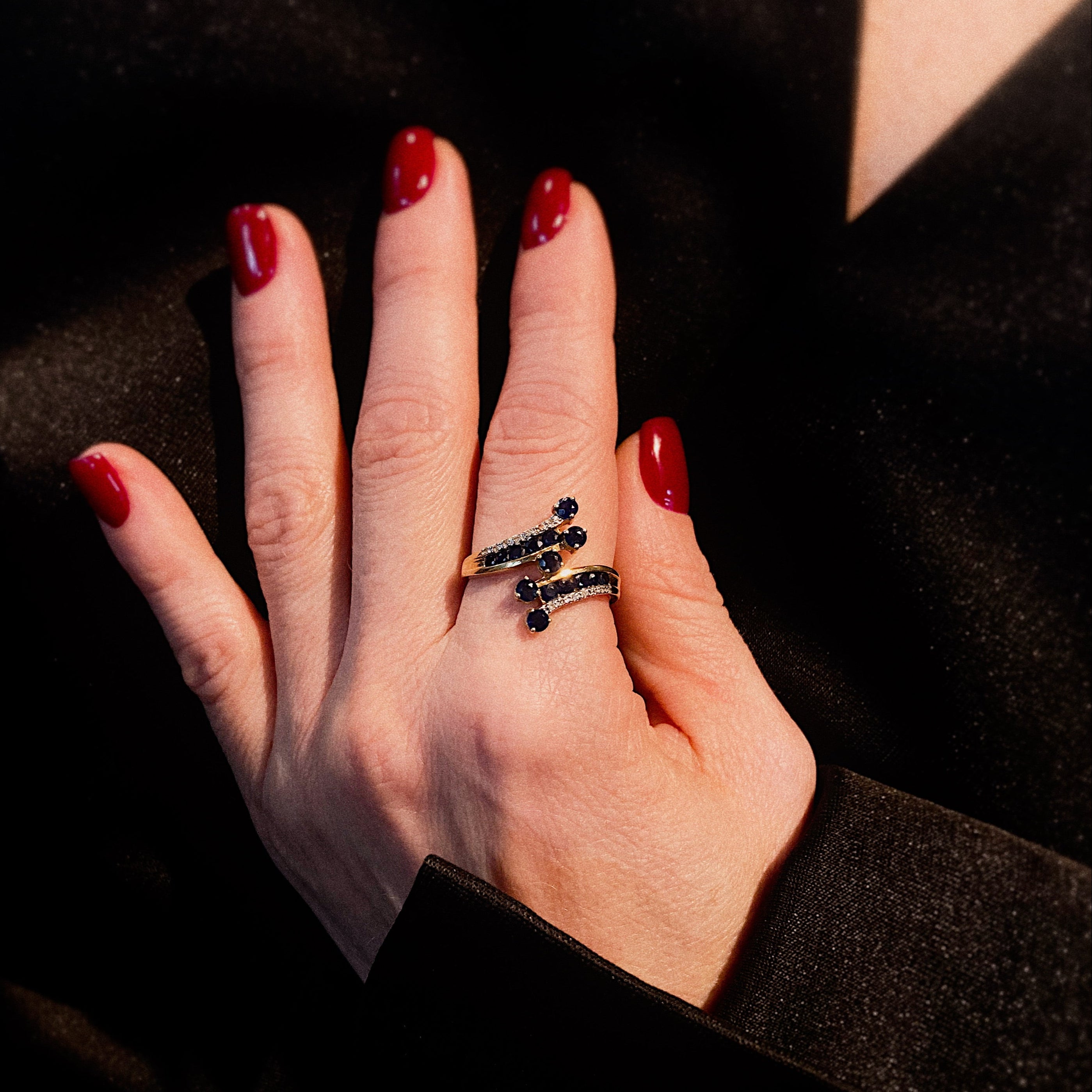 Model wearing the vintage gold sapphire and diamond bypass cocktail ring.