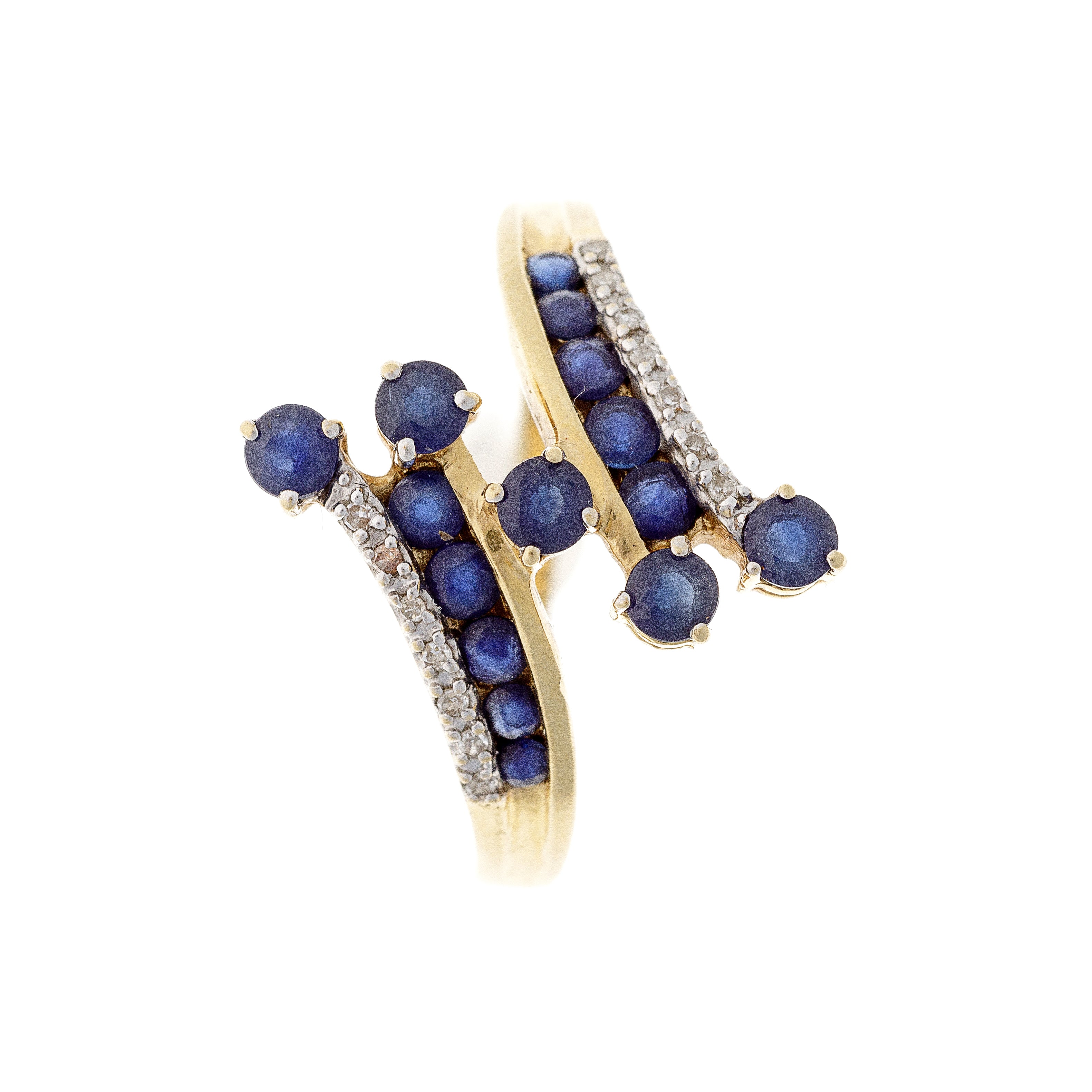 A vintage 18K gold bypass ring featuring deep blue sapphires and sparkling diamonds, elegantly arranged in a flowing, dynamic design.