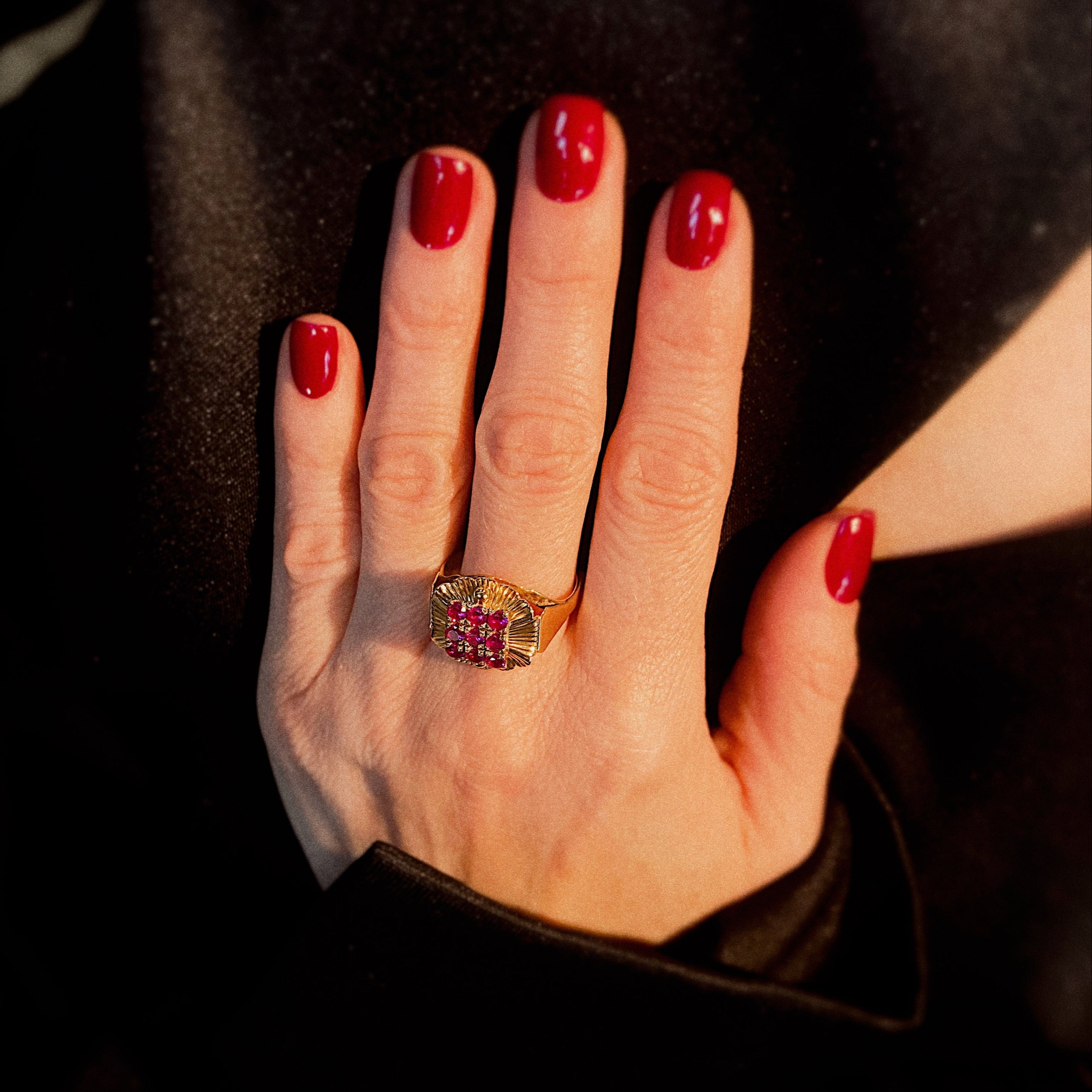 Model wearing the vintage gold floral cocktail ring with lab-grown rubies.