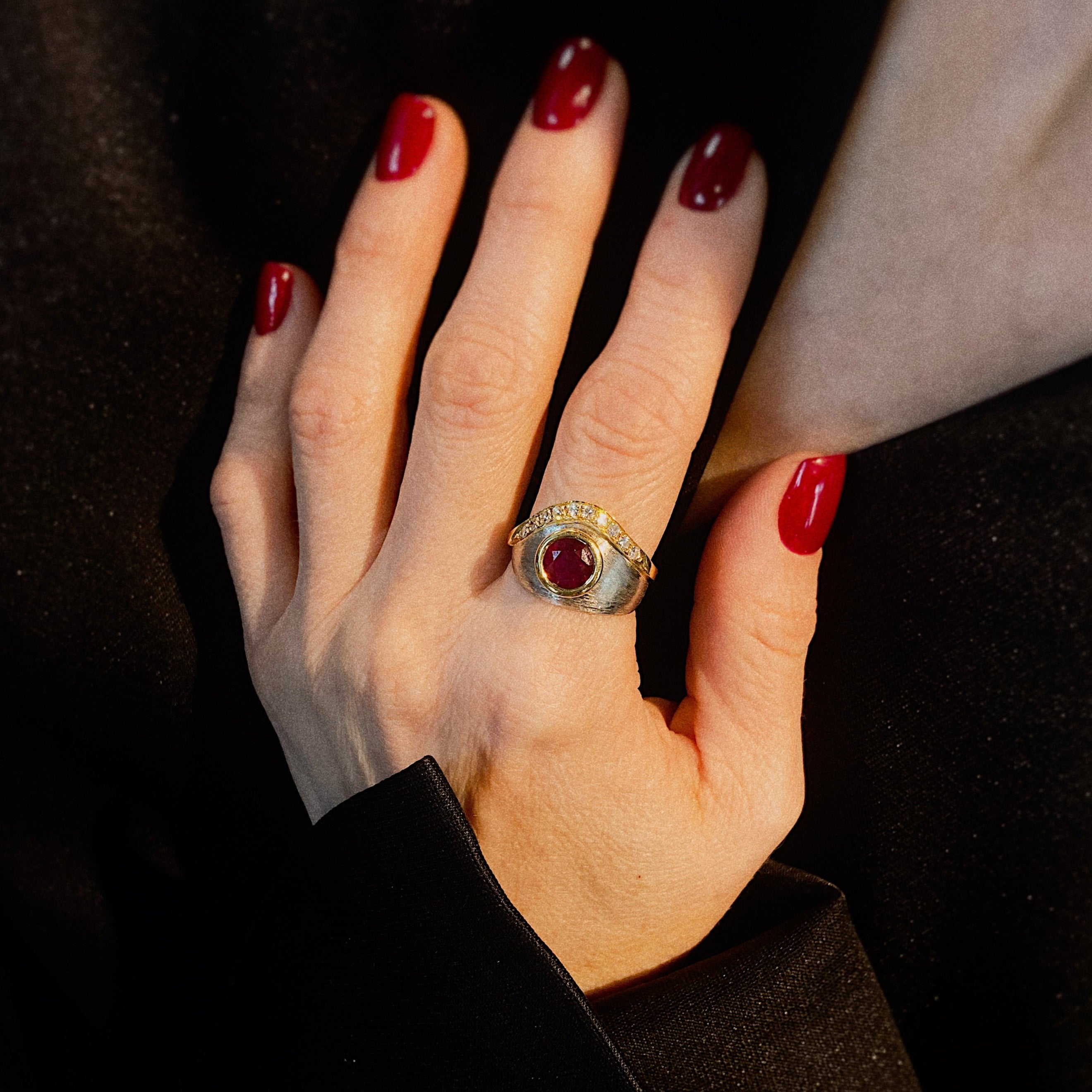 Model wearing the vintage platinum and gold statement ring with ruby and diamonds.