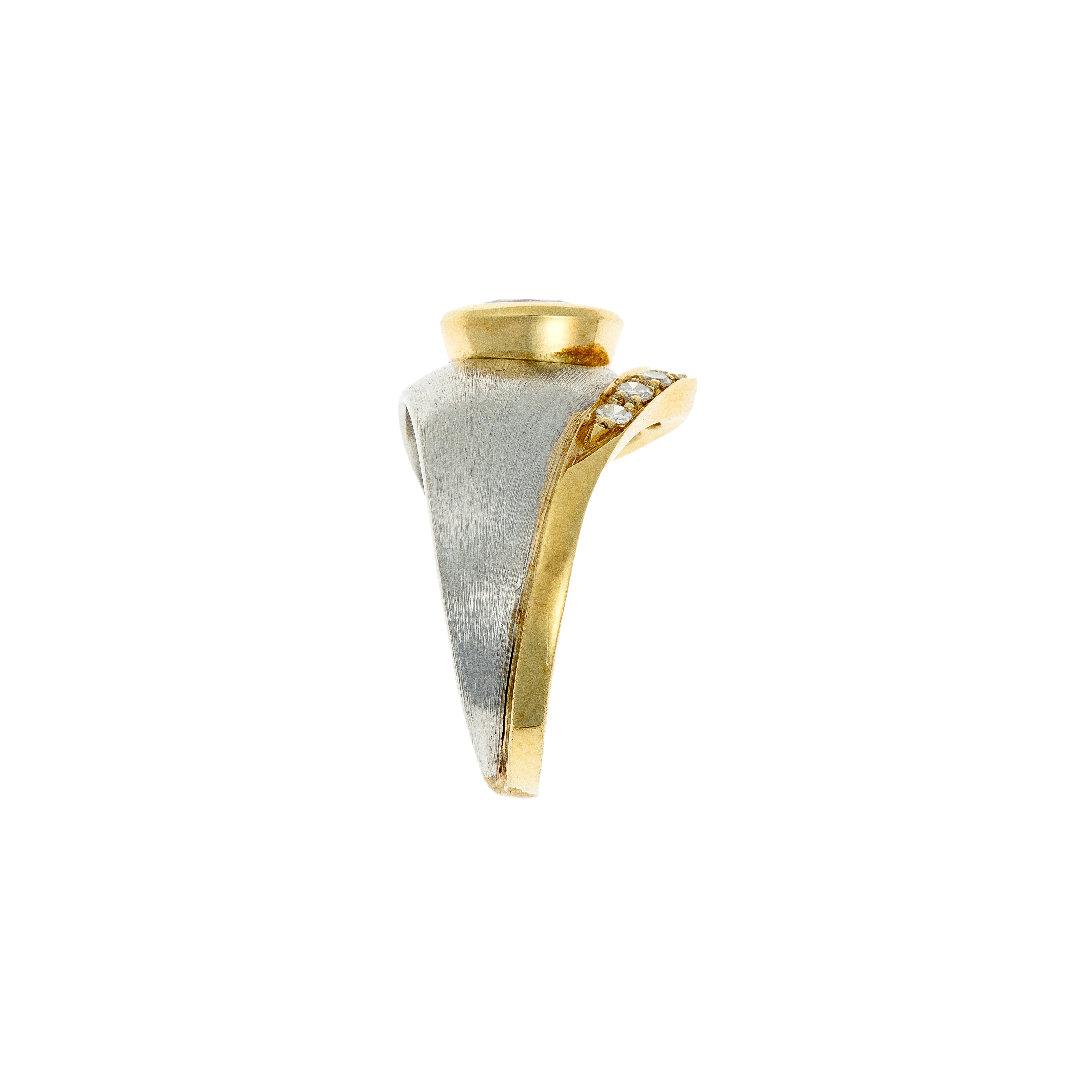 Side view of the vintage ring showing the elevated bezel-set ruby and the curved diamond channel.