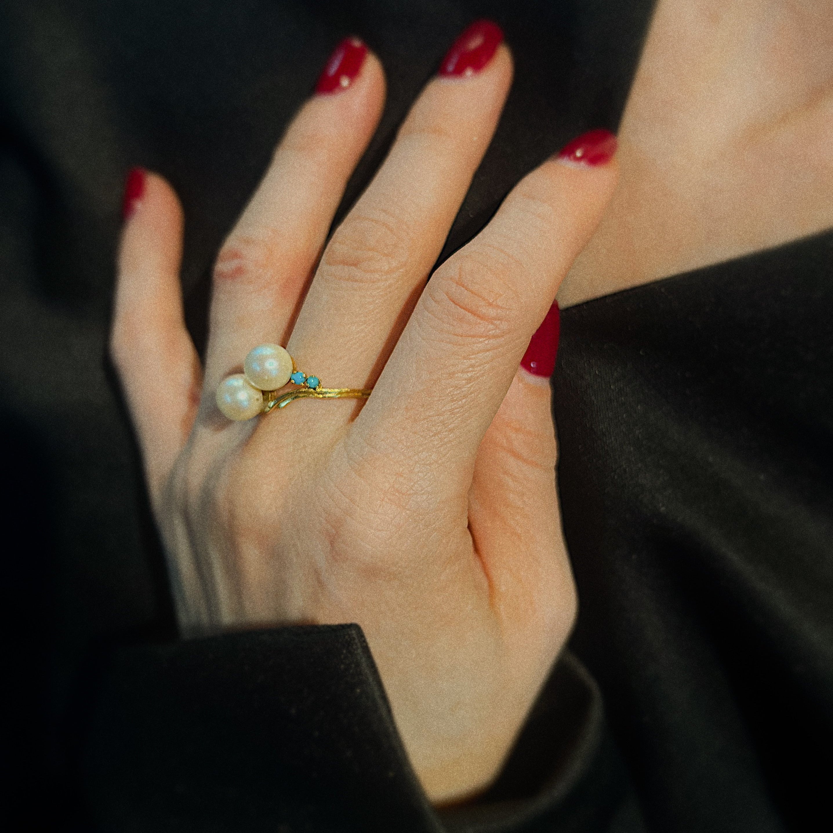 Model wearing the vintage gold cocktail ring with cultured pearls and turquoise.