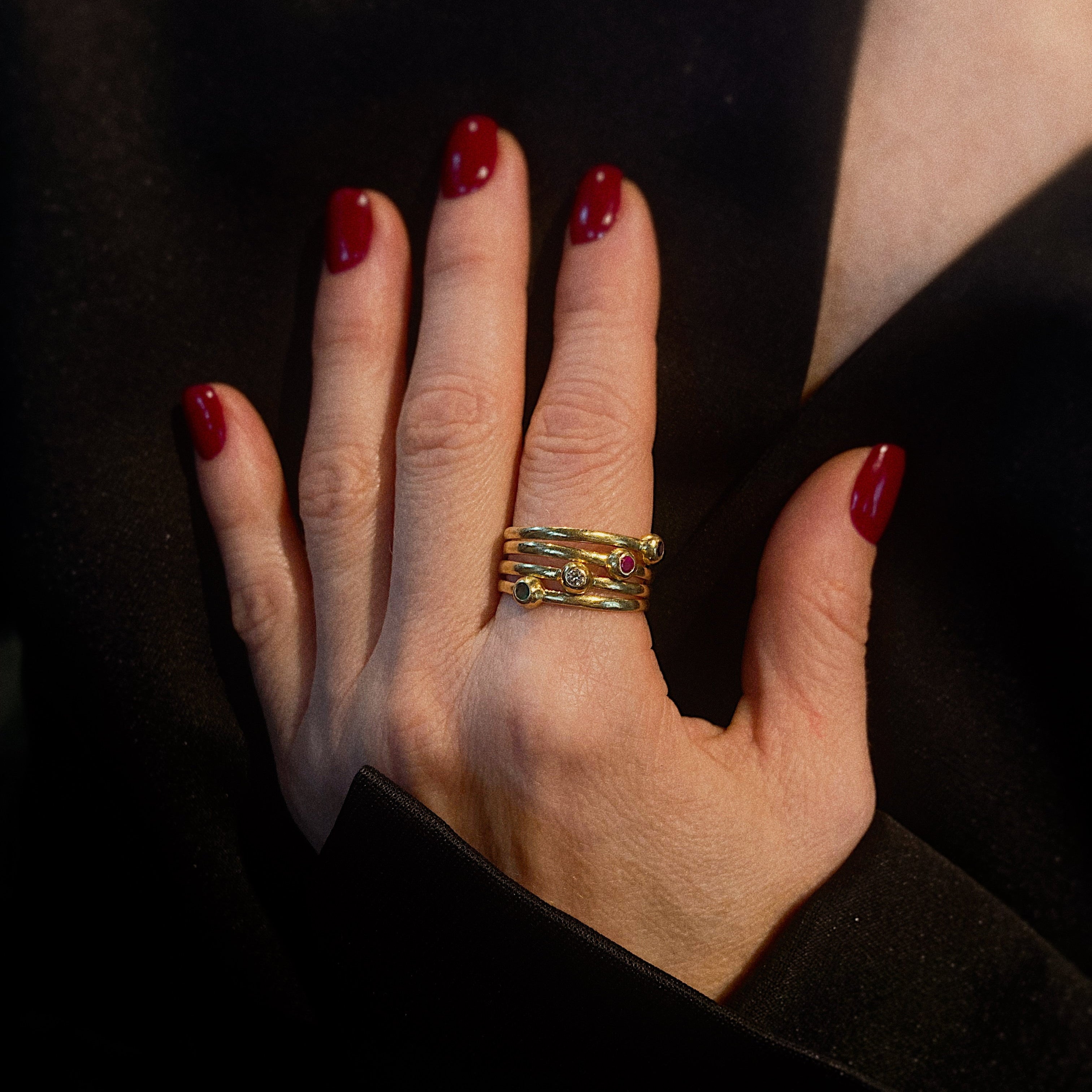 Model wearing the vintage gold ring with diamond, emerald, sapphire and ruby.