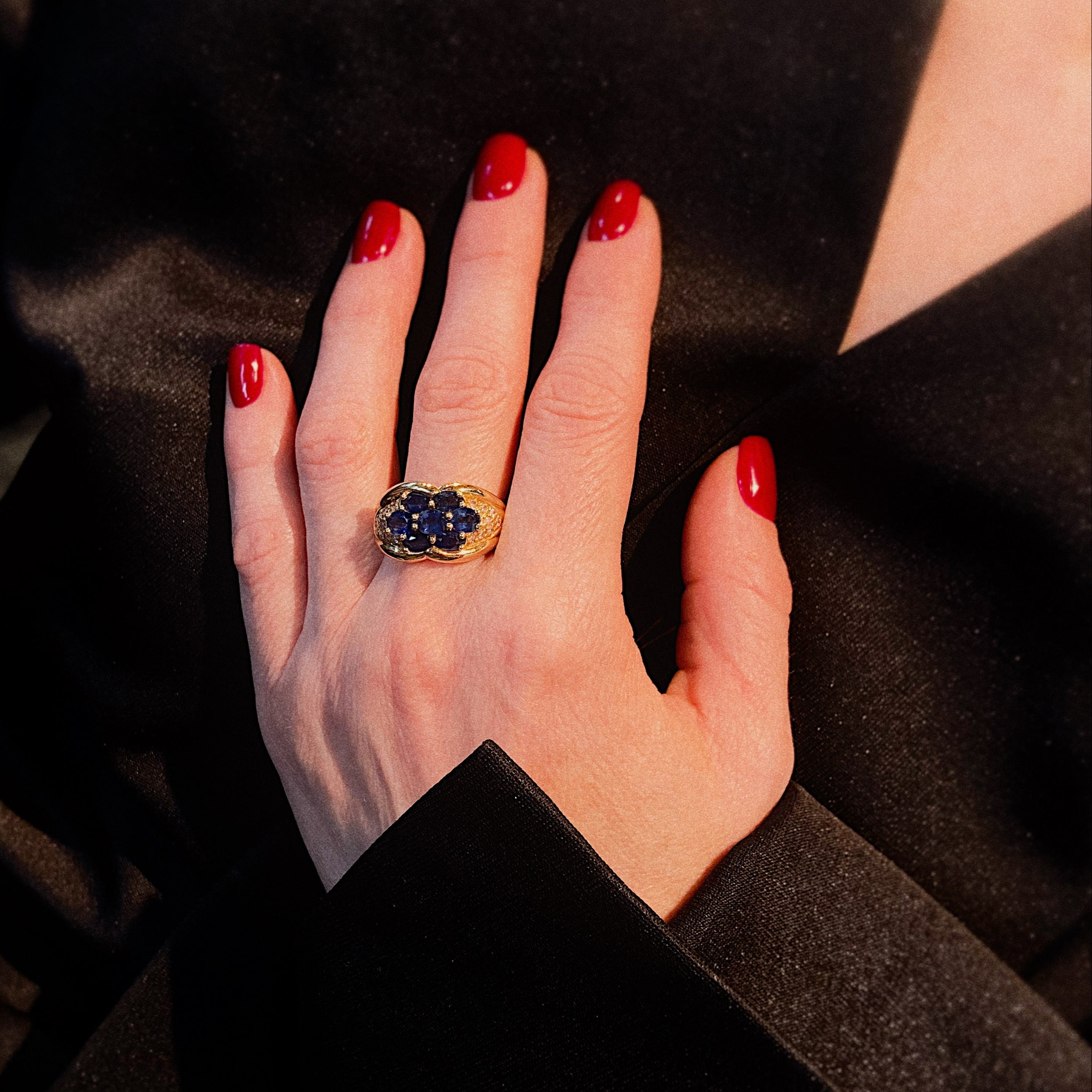Model wearing the contemporary vintage gold sapphire cluster statement cocktail ring.