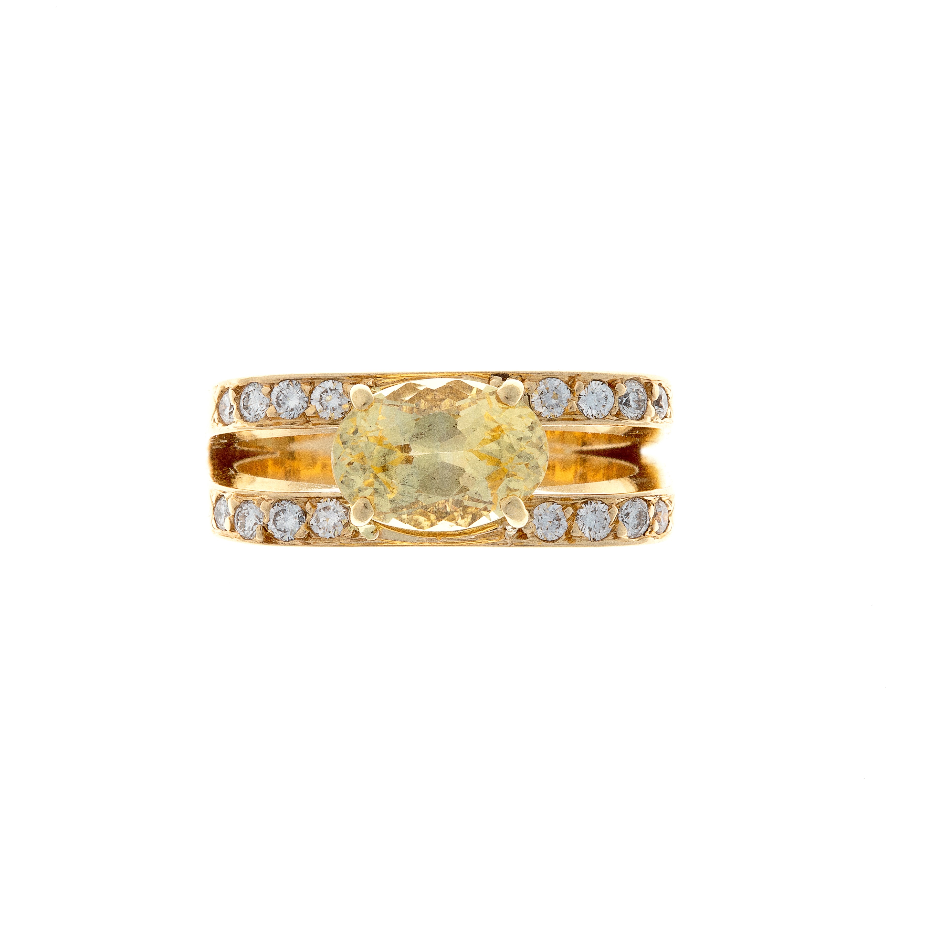 Vintage French 18K gold cocktail statement ring with oval yellow sapphire framed by brilliant-cut diamonds.