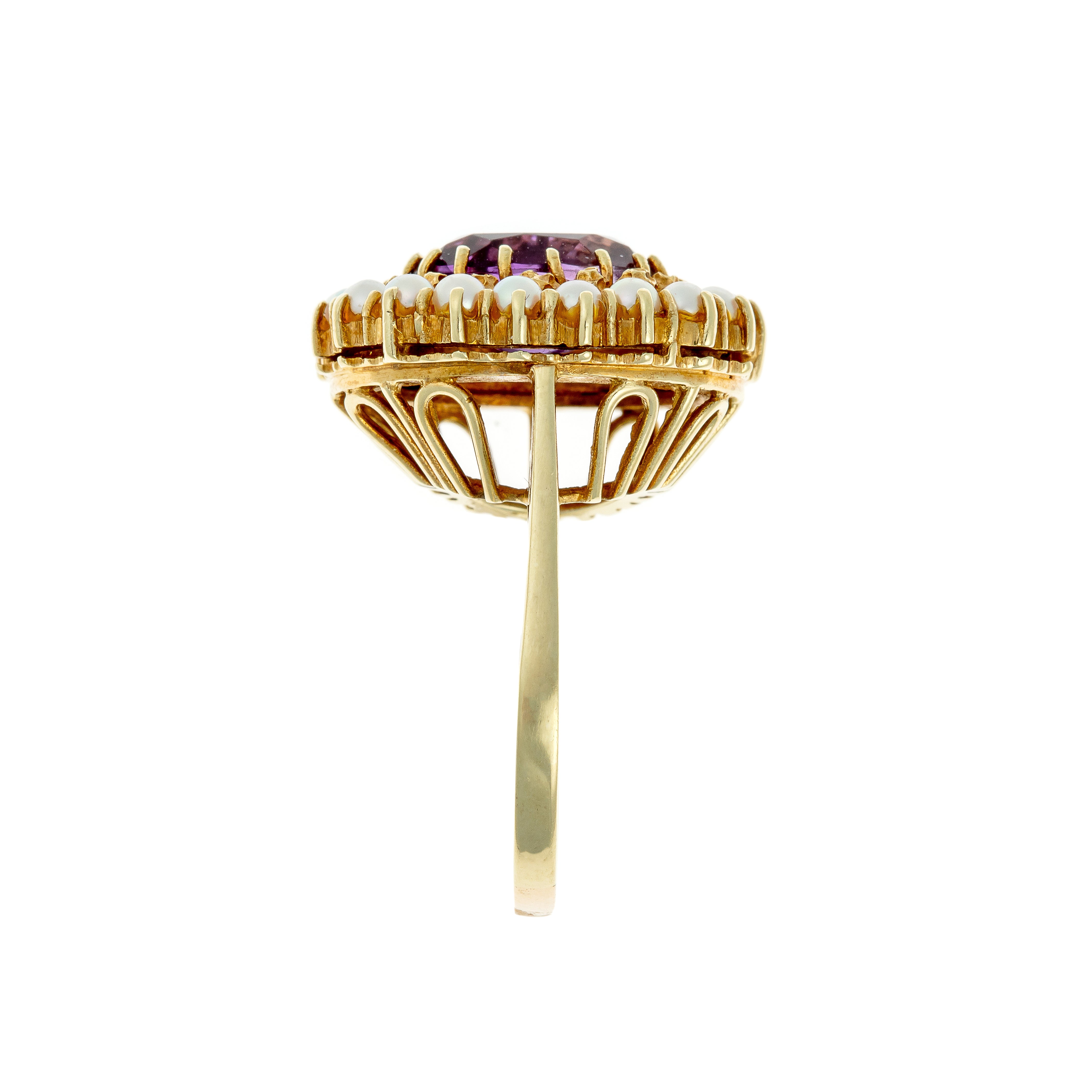 Side view of mid-century gold cocktail ring with openwork gallery and pearl halo.