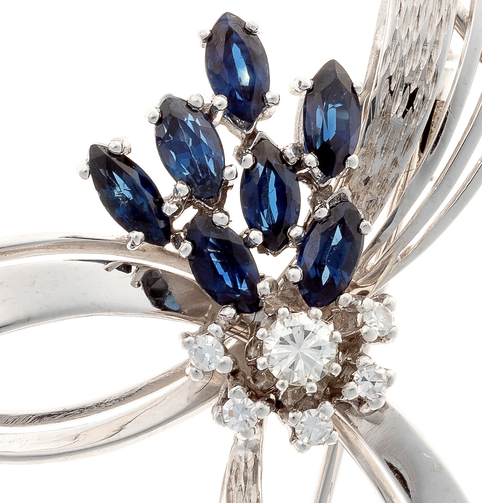 Close-up of sapphire and diamond detailing of the mid-century white gold ribbon brooch.