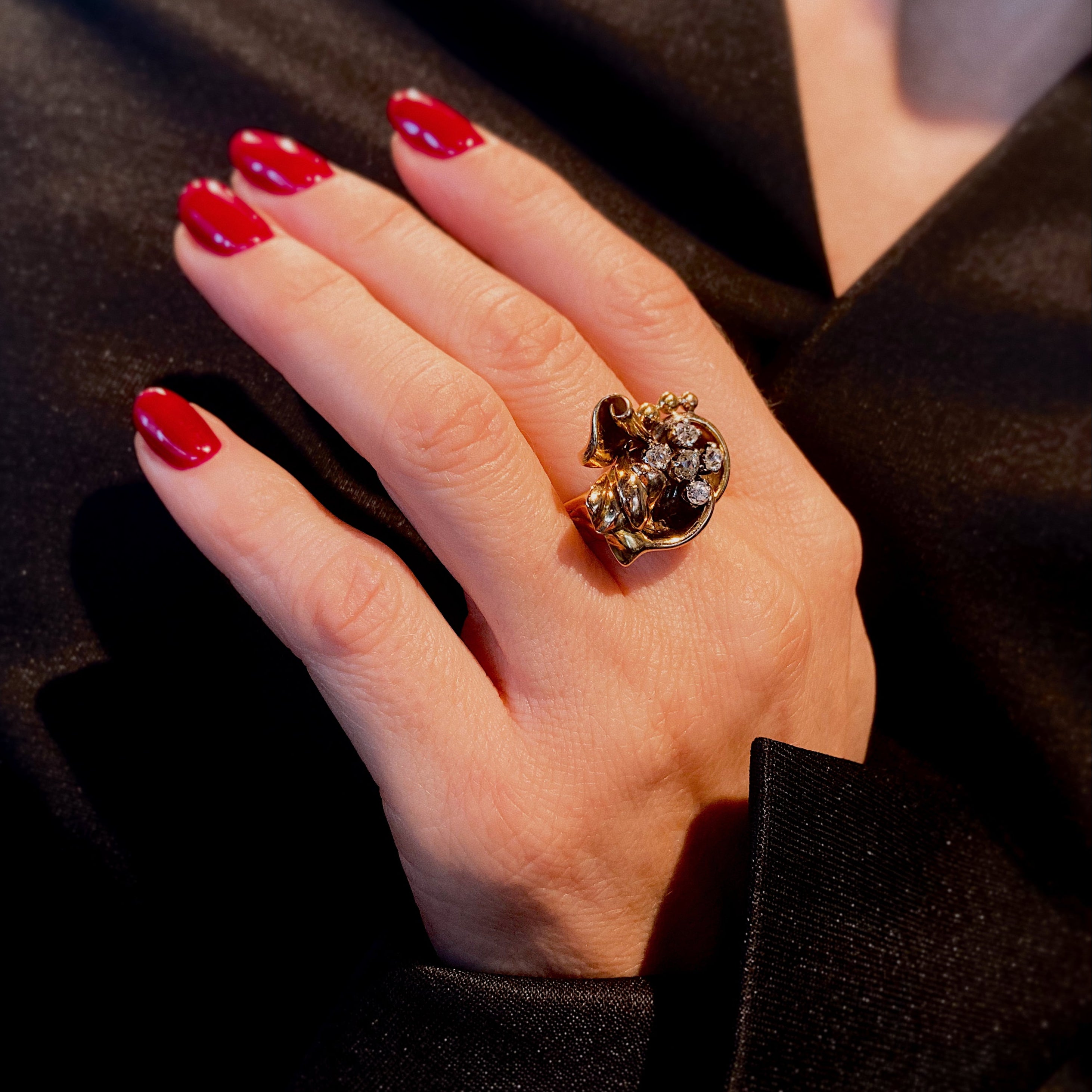 Woman wearing the vintage Retro 1940s gold and diamond floral cocktail ring.