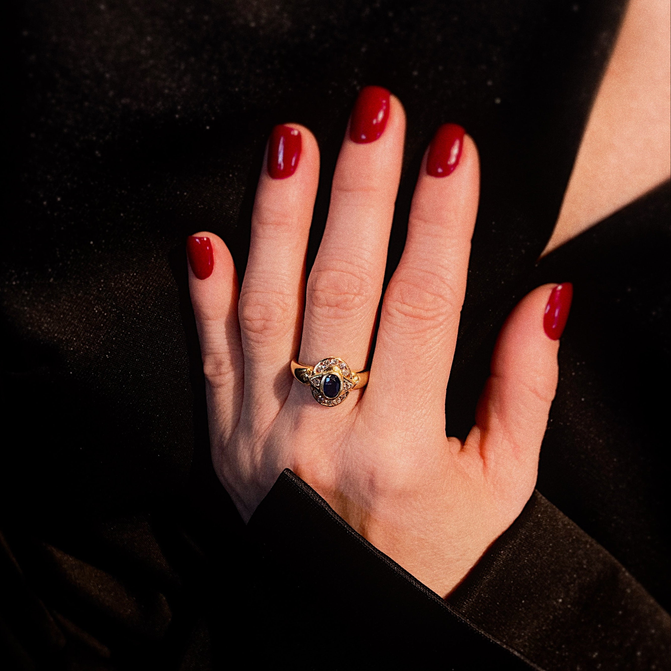 Model wearing the vintage gold sapphire and diamond halo cocktail ring.