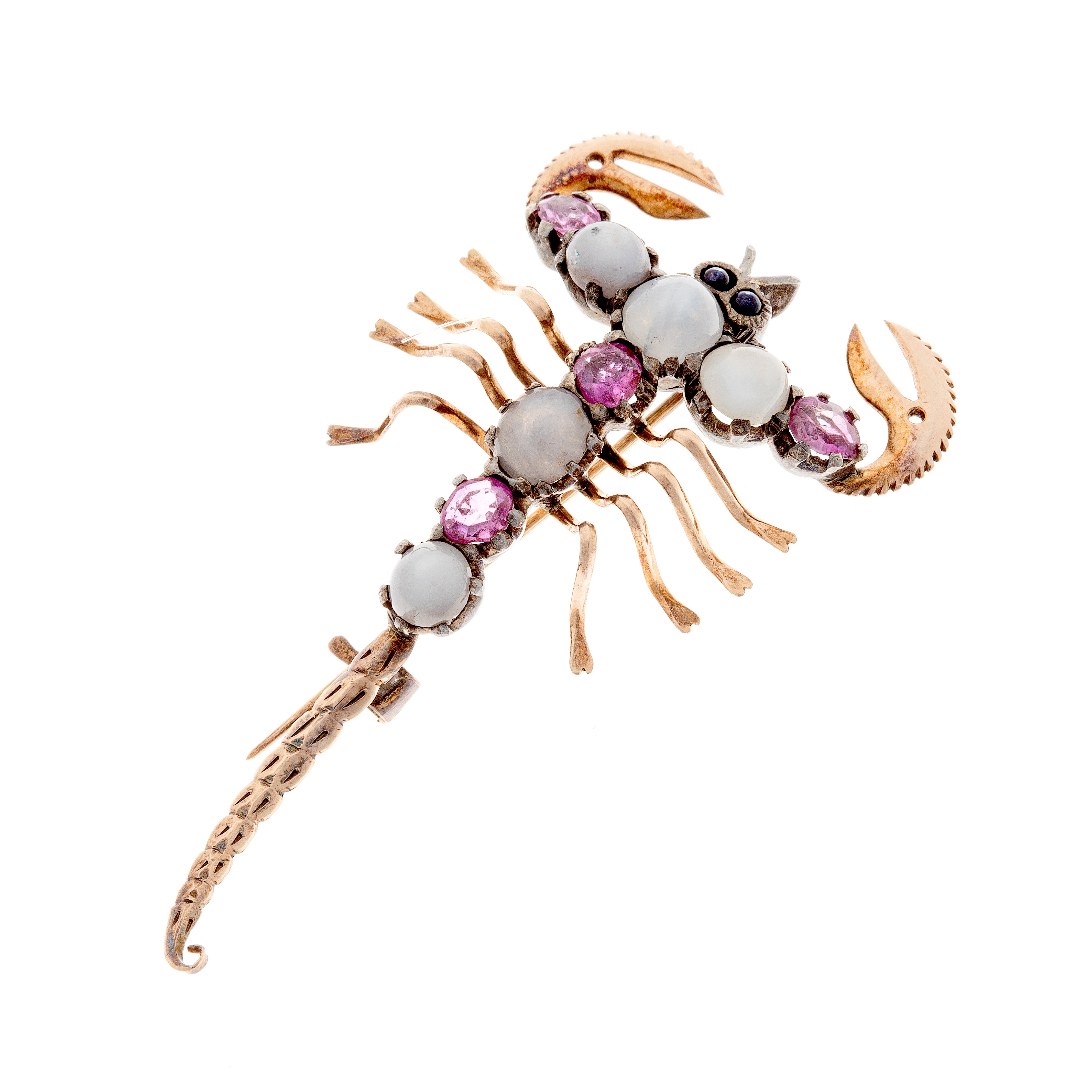 Angled view of avant-garde scorpion brooch showcasing gemstone placement and mixed metal body.