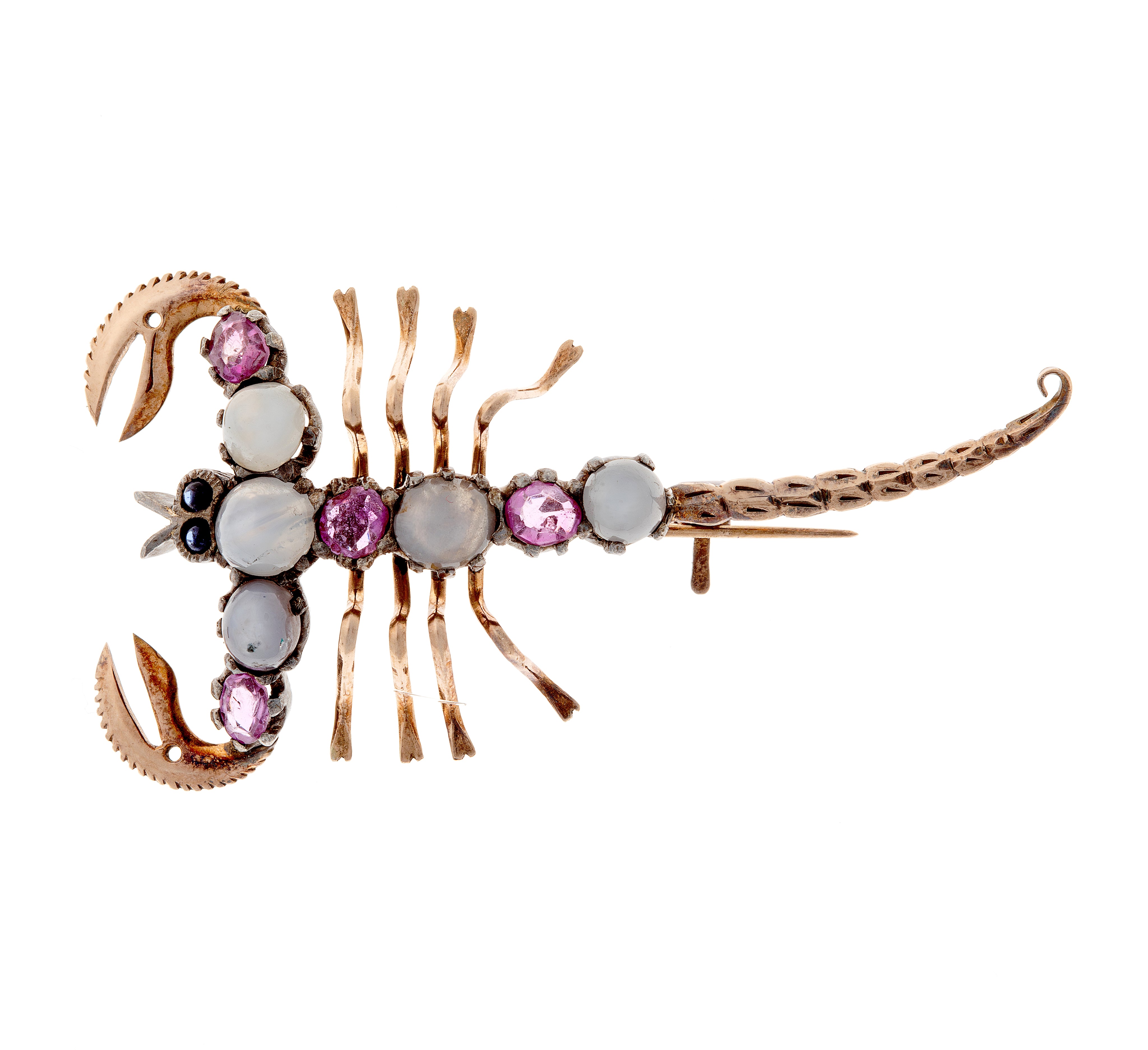 Vintage scorpion-shaped silver and gold brooch featuring star sapphires and rubies in artistic cabochon setting.