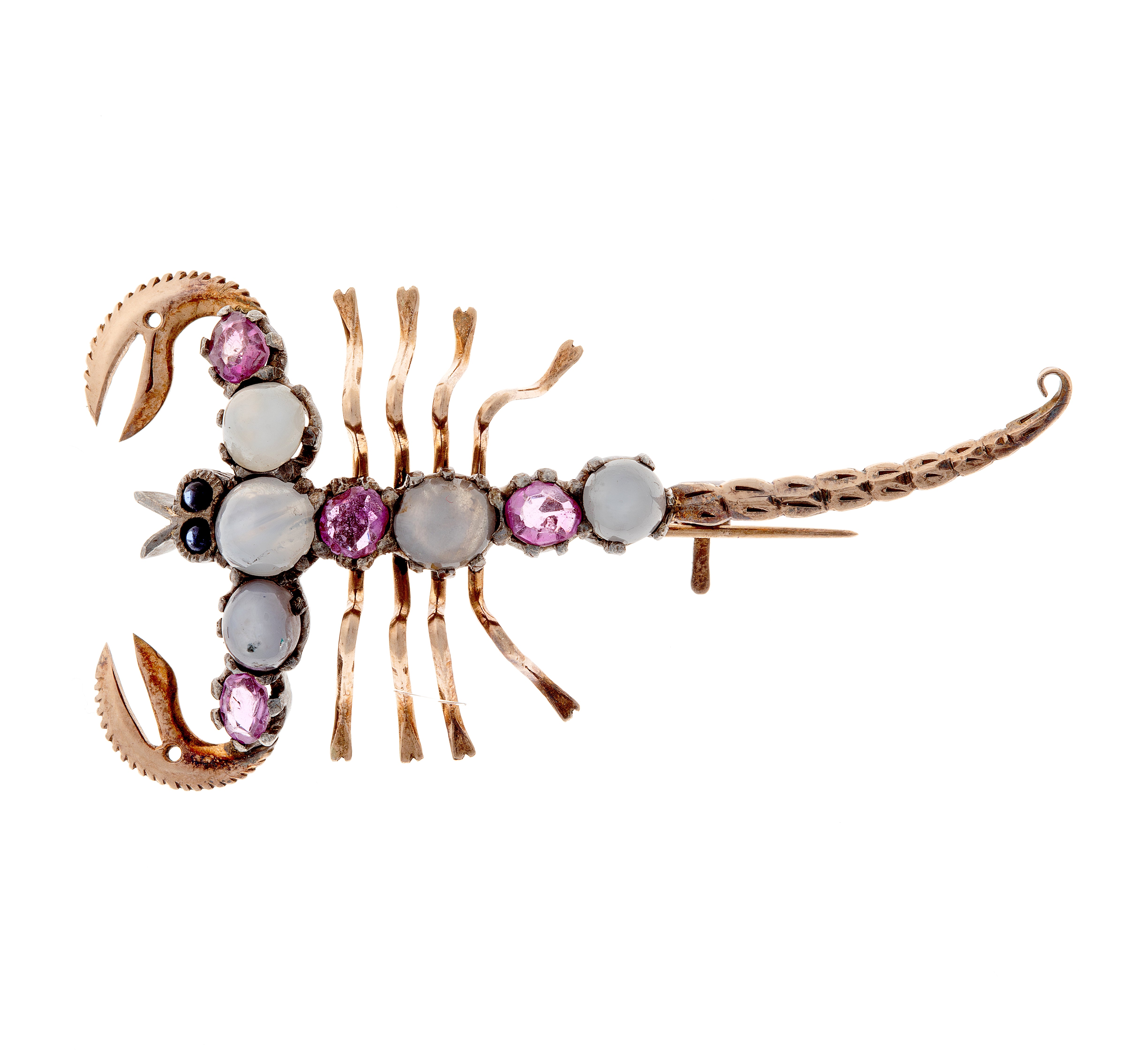 Vintage scorpion-shaped silver and gold brooch featuring star sapphires and rubies in artistic cabochon setting.