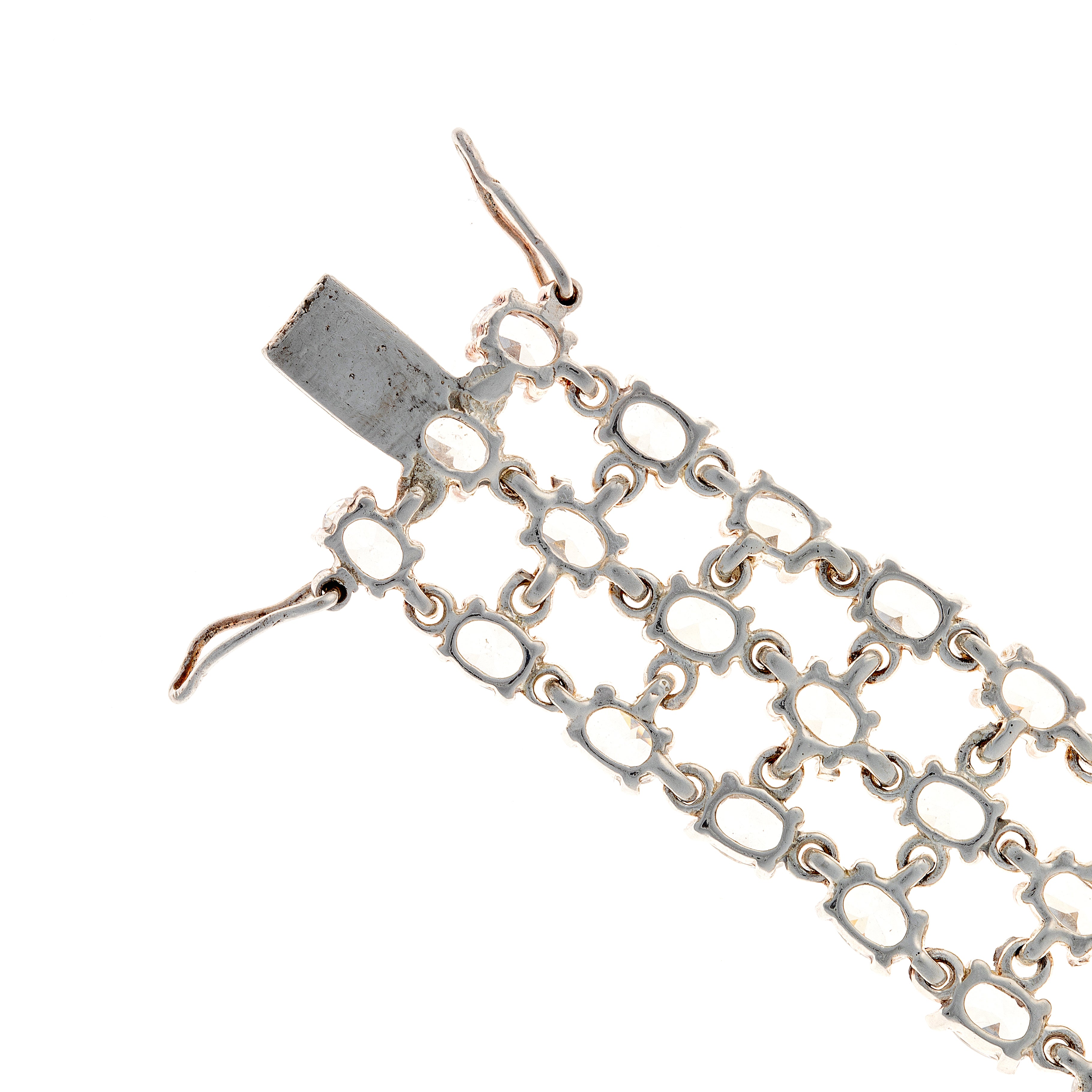 Close-up of bracelet clasp and end link details on sterling silver tennis bracelet with zircon stones.